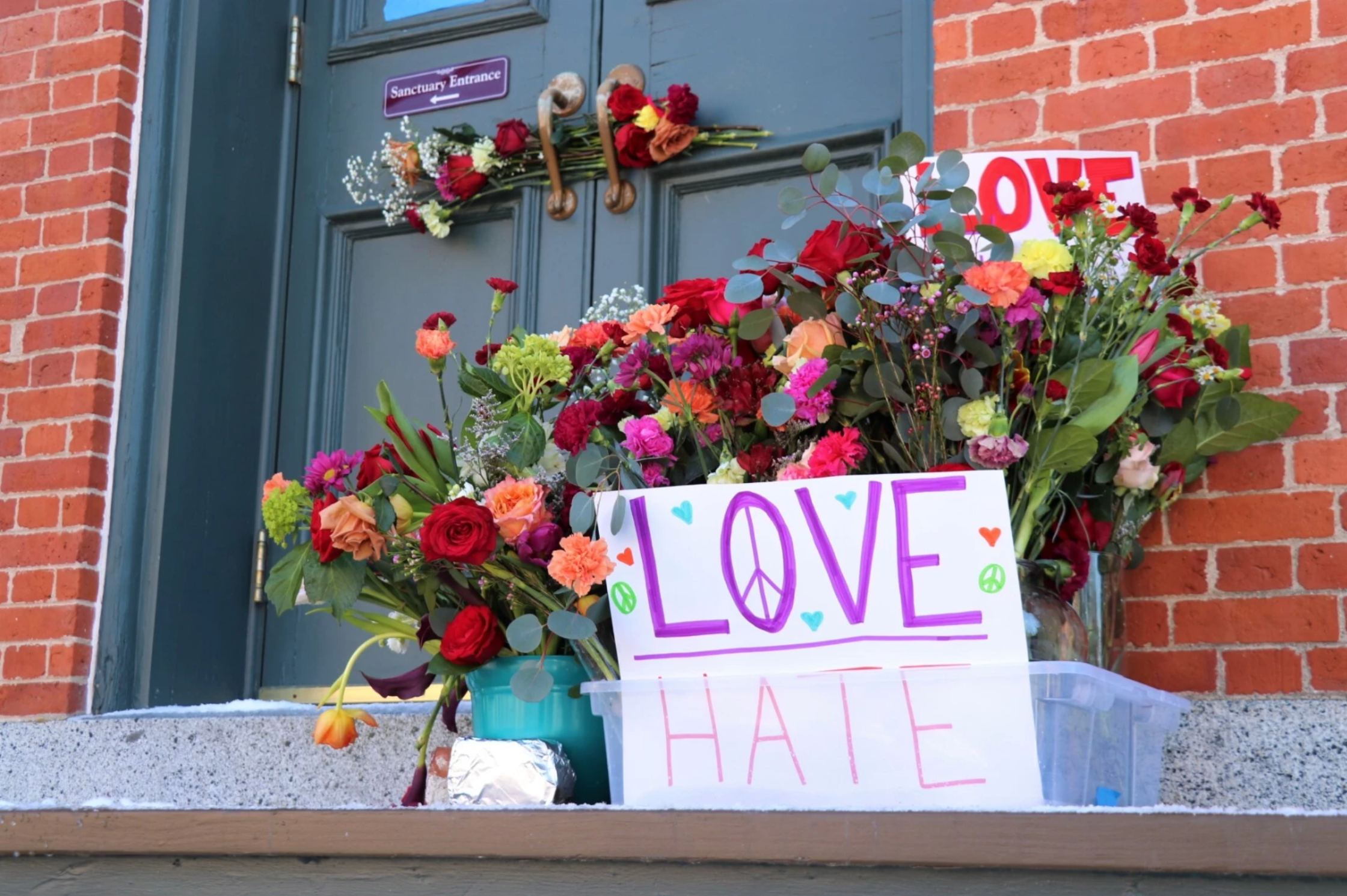 Following a spate of vandalism, Portsmouth organized 'Love Blooms Here,' an event where flowers were left with impacted businesses and Temple Israel. (Dan Tuohy/NHPR)