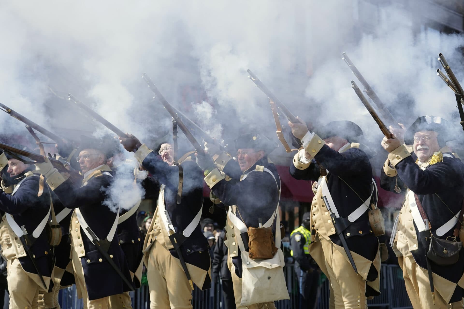 Re-enactors portraying members of the American forces during the Revolutionary War fire their muskets during the annual St. Patrick's Day parade. (Steven Senne/AP)