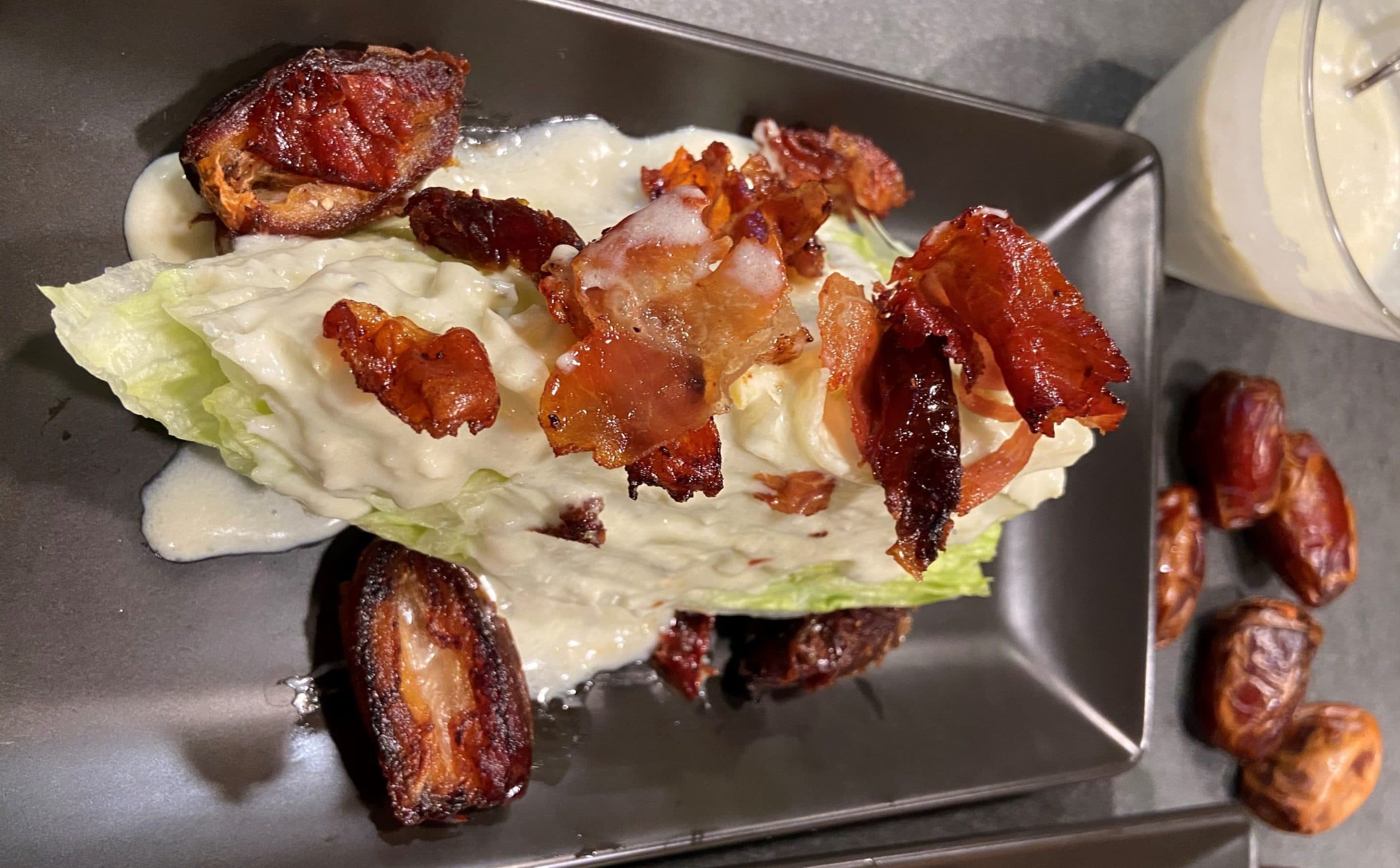 Wedge salad with sauteed dates, blue cheese dressing and crispy prosciutto. (Kathy Gunst/Here &amp; Now)