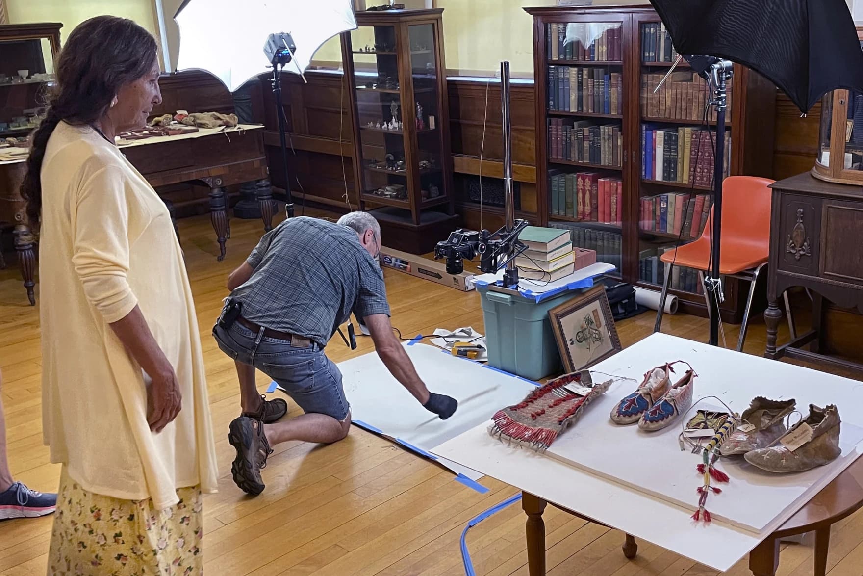 Leola One Feather, left, of the Oglala Sioux Tribe, observes as John Willis photographs Native American artifacts. (David Goldman/AP)