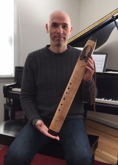 To play this dual-chambered flute, Eric Shimelonis plays a drone note through the left chamber, while playing melody on the right. (Courtesy of Rebecca Sheir)