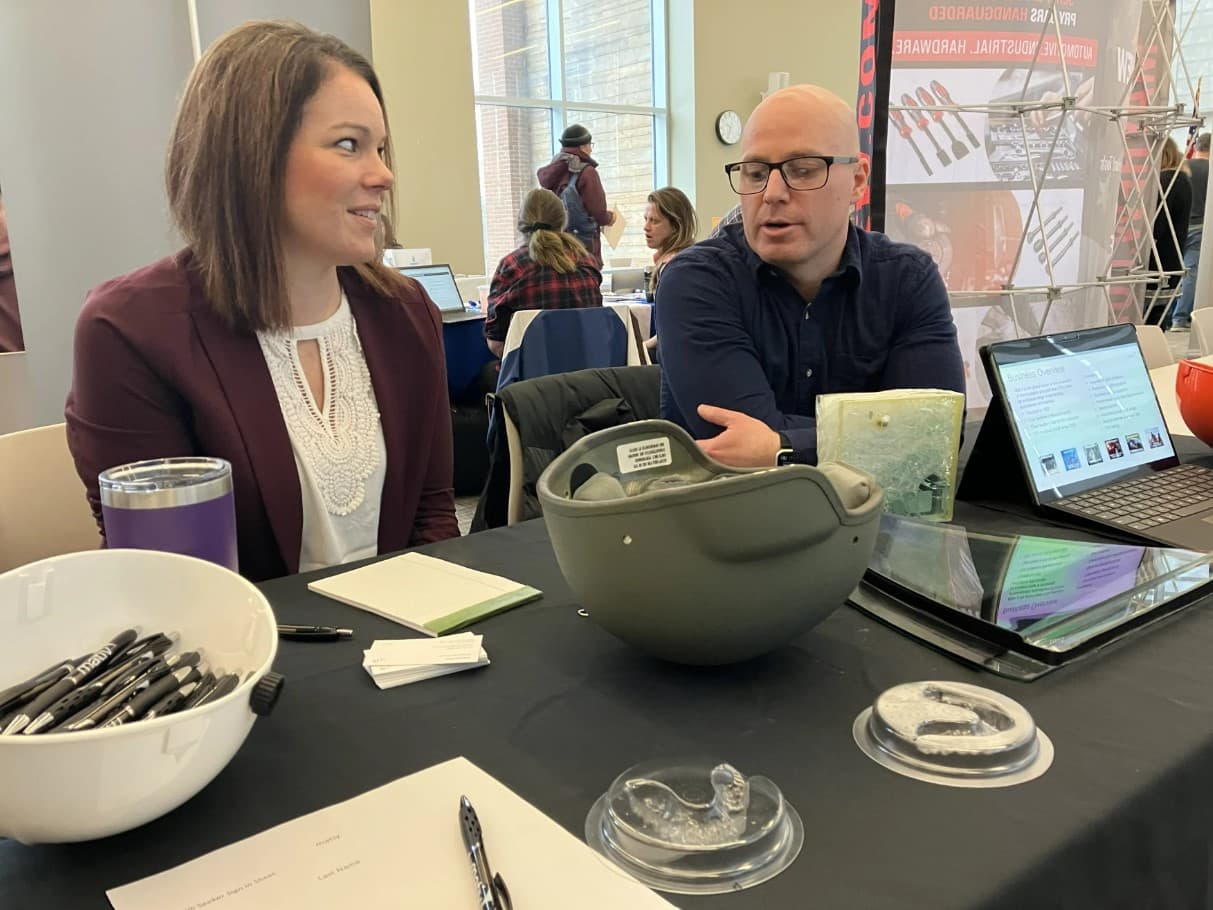 Crystal Fish and Christian Martin represent Mativ, a plastics manufacturer, at a job fair in Greenfield, Massachusetts, on Feb. 15, 2023. Fish said she is not aware of any applicants who have had trouble submitting a job application online. (Nancy Eve Cohen/NEPM)