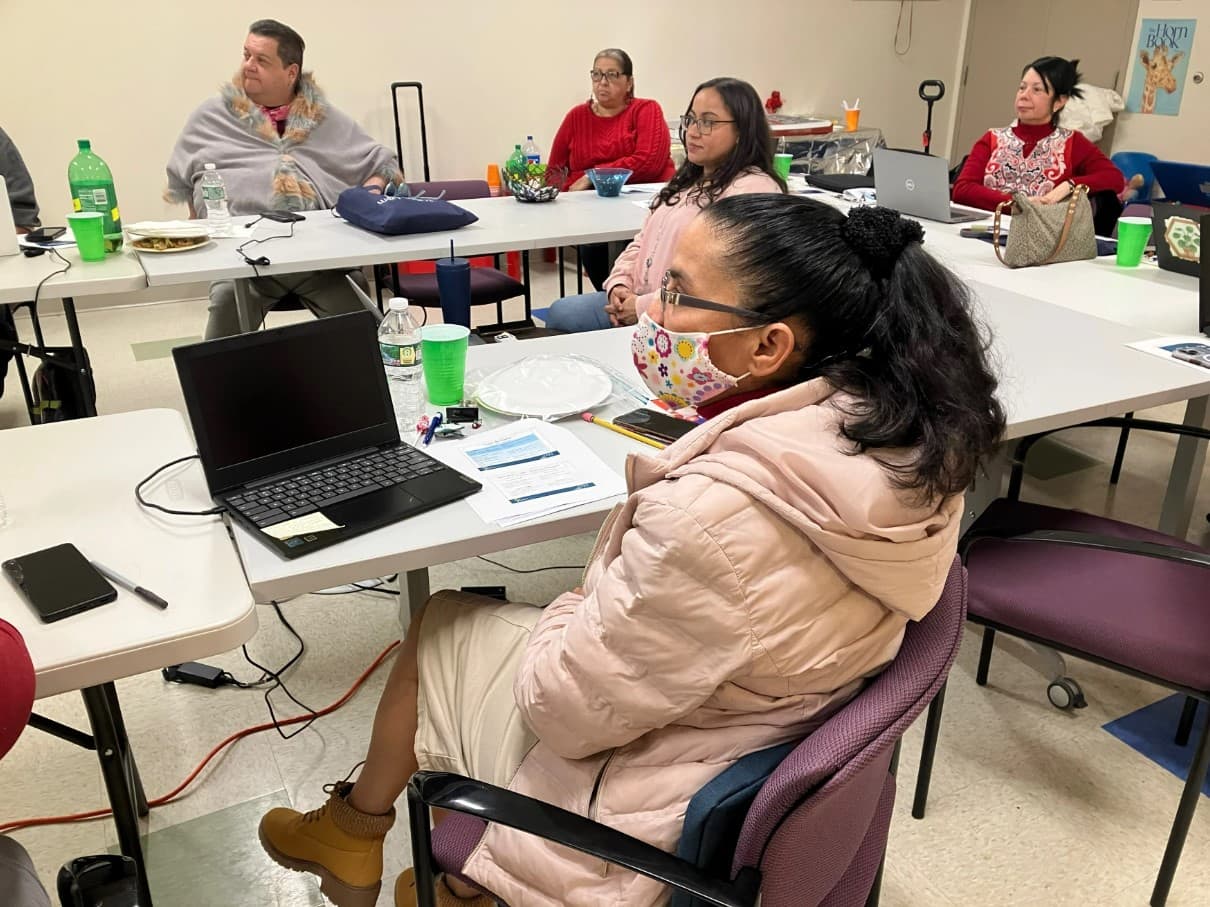 Grisel Monserrate (front) attends her second computer course offered by Way Finders in Holyoke, Massachusetts, on February 14, 2023. Monserrate said she feels more confident she can achieve her goals after learning computer skills. (Nancy Eve Cohen/NEPM)