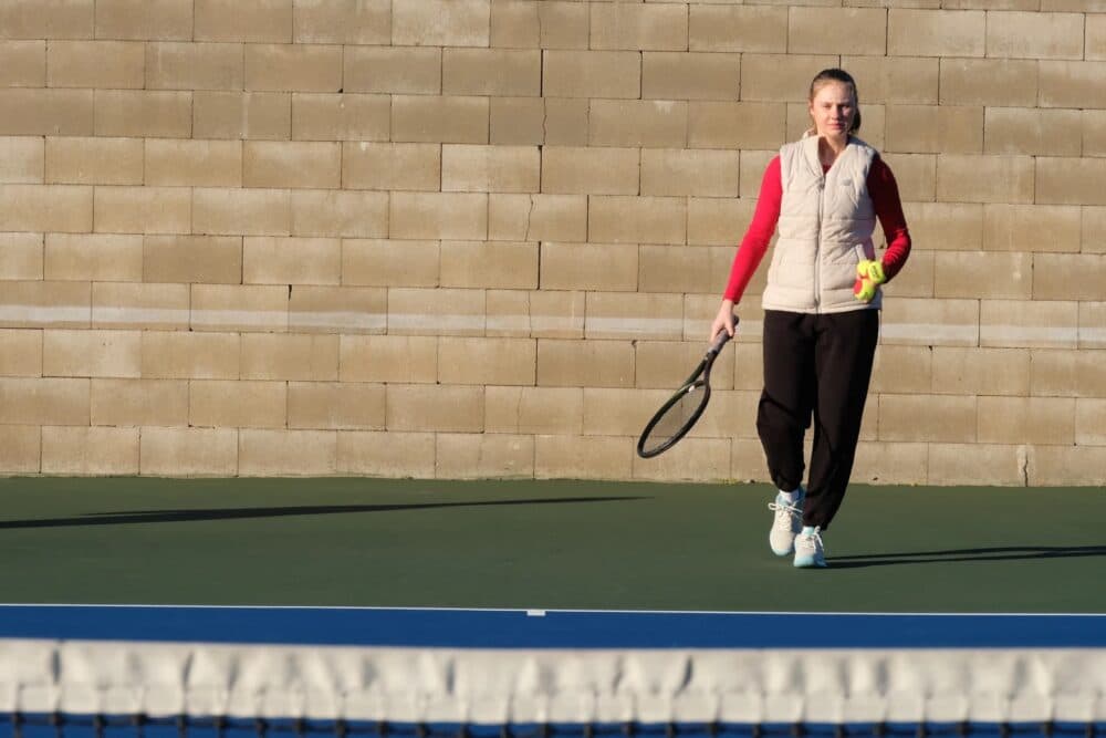 Polina Makarenko prepares to serve a tennis ball during practice. (Todd Bookman/NHPR)