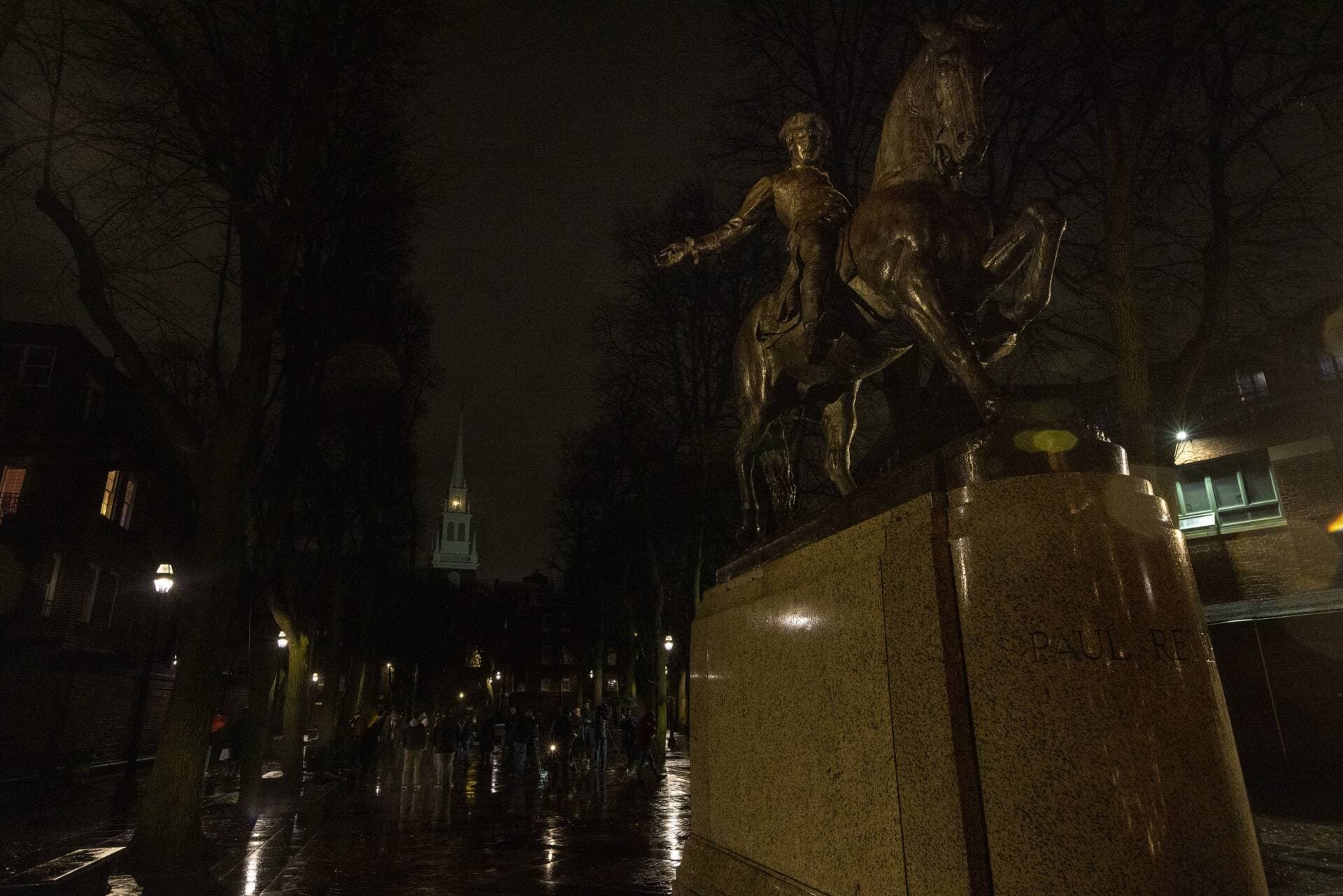 The statue of Paul Revere in the forefront as the lanterns are lit in the Old North Church on Jan. 5, 2022. (Jesse Costa/WBUR)