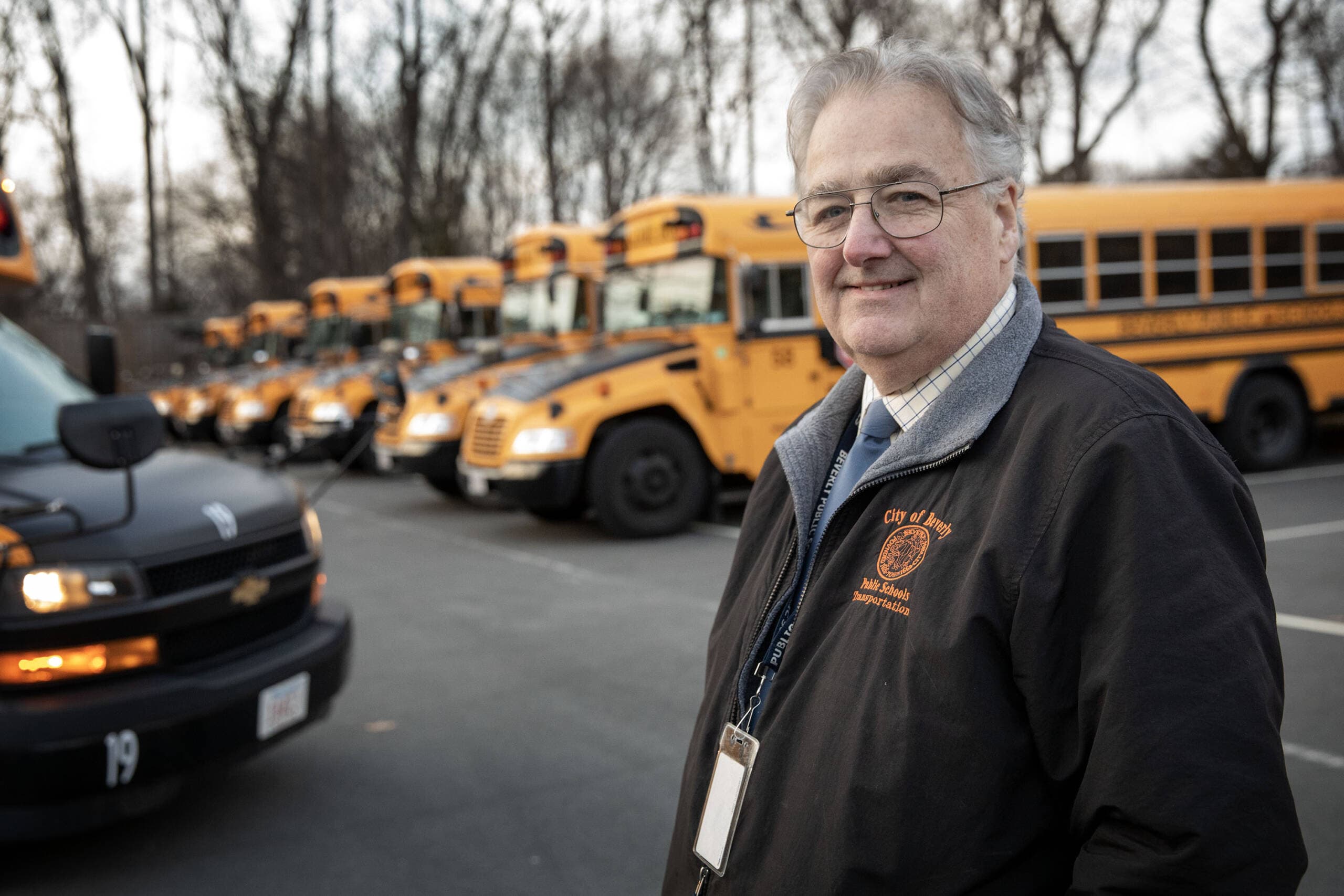 District transportation director Dana Cruickshank, stands in the parking lot at Beverly High School. (Robin Lubbock/WBUR)