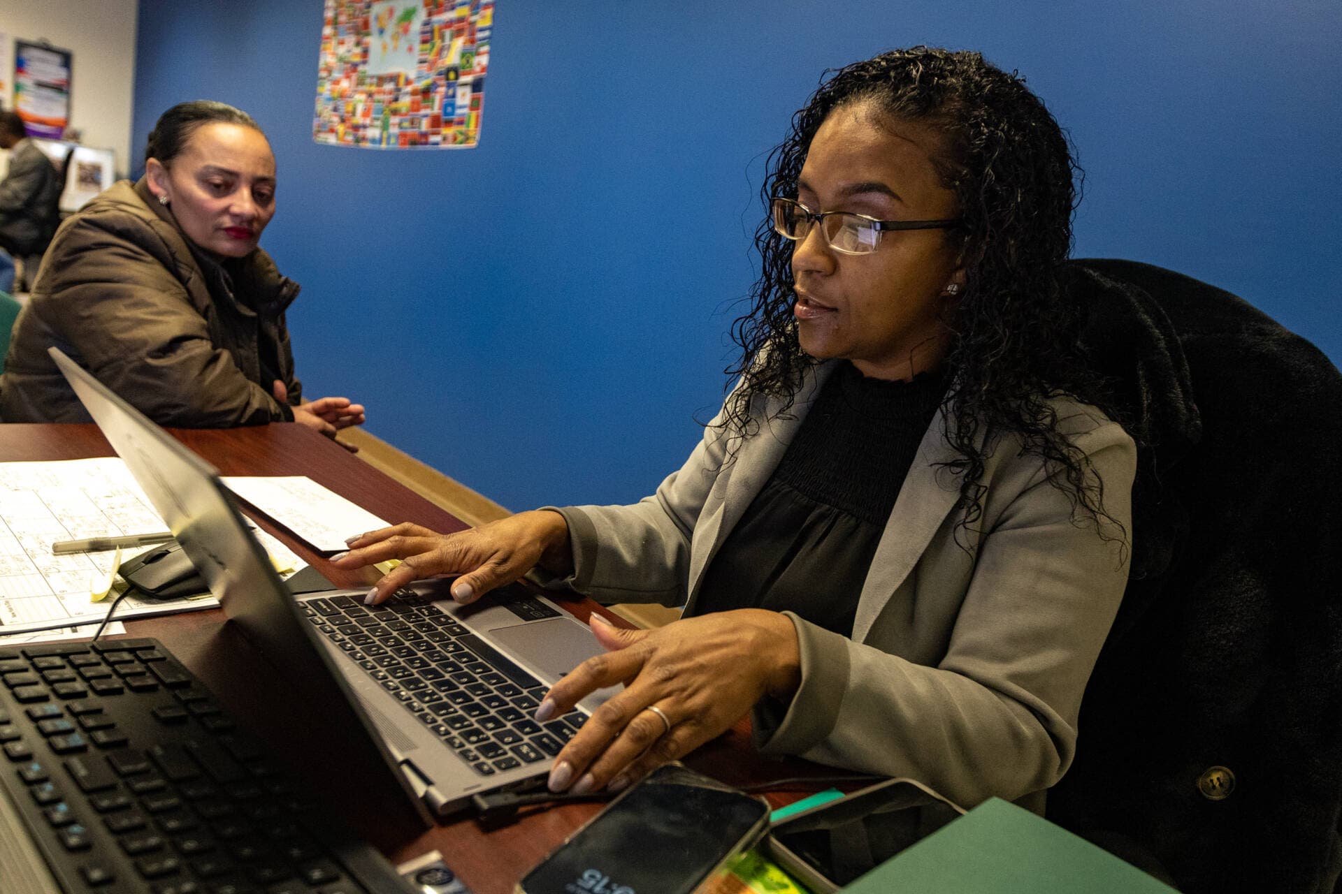 ELL Family Advocate Adele Gomes assists Gilda Andrade, who’s native language is Cape Verdean, at the Brockton Public Schools Multilingual Parent Communication Center. (Jesse Costa/WBUR)