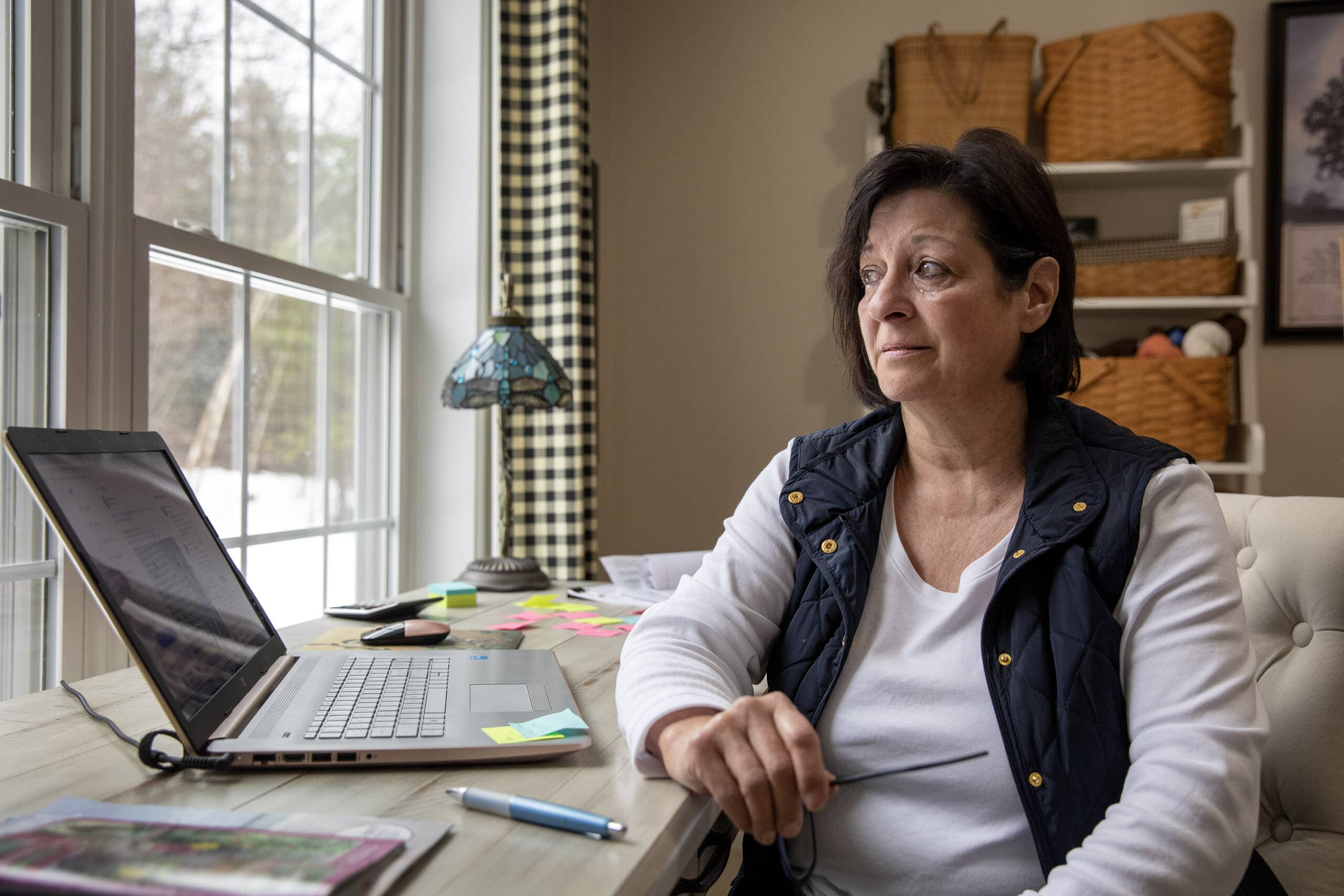 Diane Cotter becomes emotional as she discusses firefighters who have lost their lives to cancer. (Robin Lubbock/WBUR)