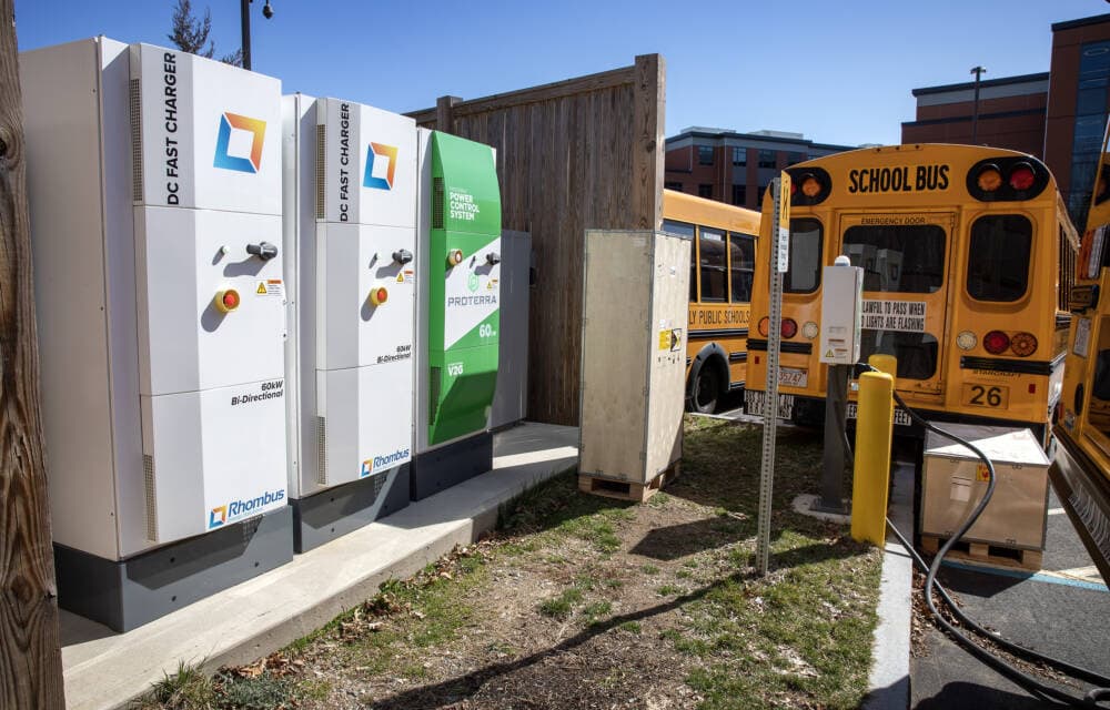 hree 60kW bi-directional chargers stand in the school bus parking lot in Beverly, Mass. (Robin Lubbock/WBUR)