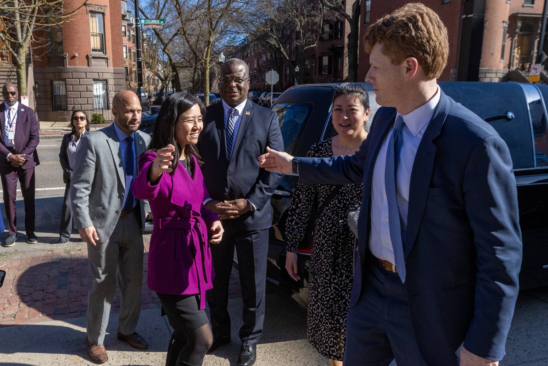 Boston Mayor Michelle Wu greets former U.S Rep. Joe Kennedy III outside of Union United Methodist Church in the South End for the public viewing of Mel King. (Jesse Costa/WBUR)
