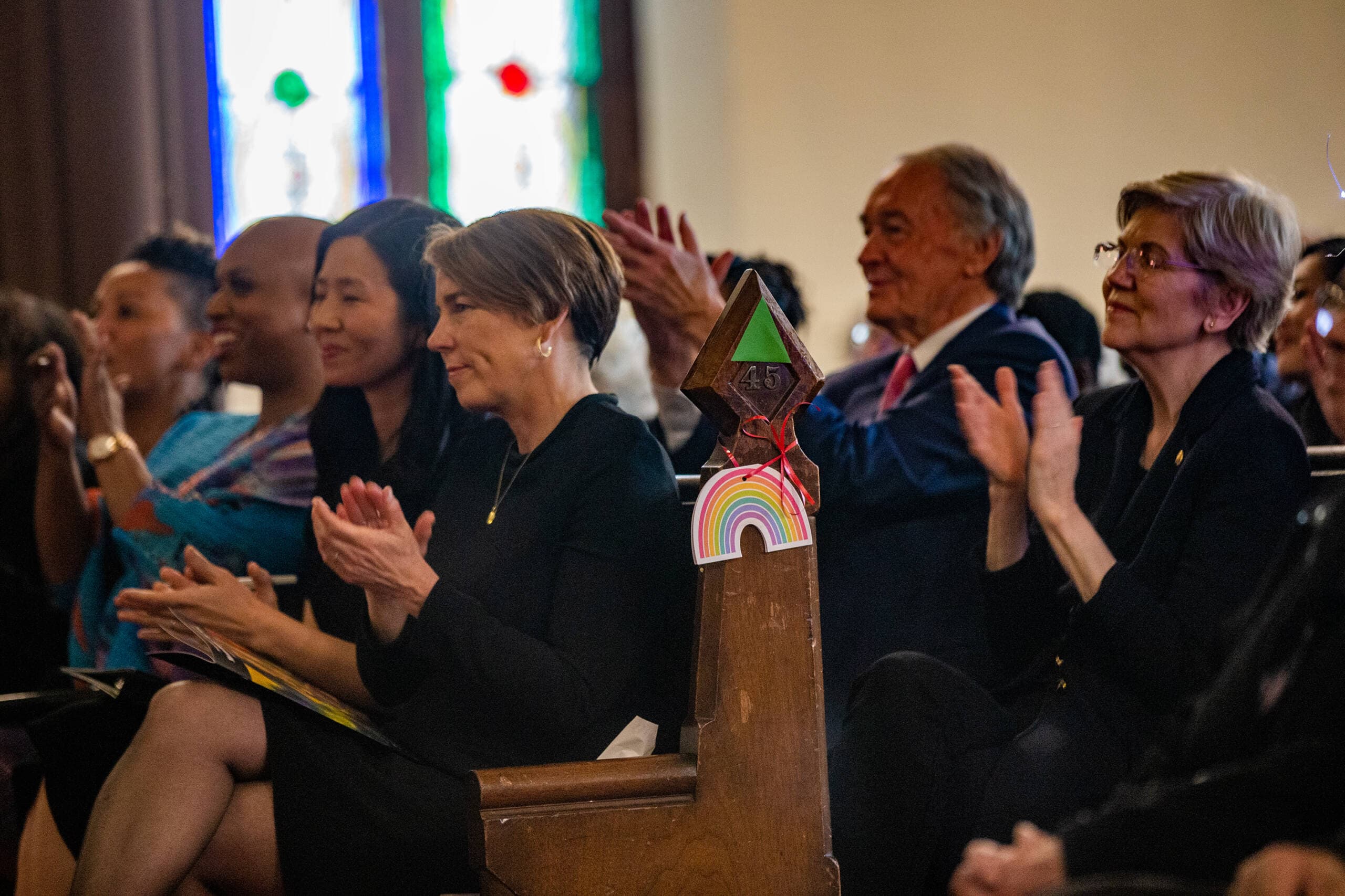 (L-R) U.S. Rep. Ayanna Pressley, Boston Mayor Michelle Wu, Gov. Maura Healey and U.S. senators Ed Markey and Elizabeth Warren applaud during the funeral service of Mel King at Union United Methodist Church in the South End. (Jesse Costa/WBUR)