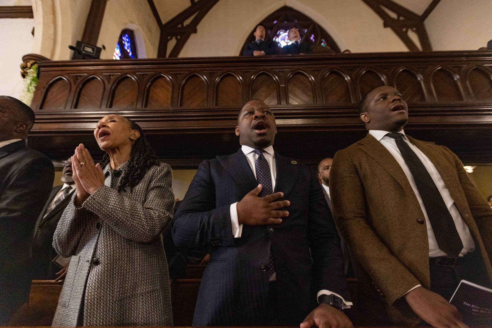 Visiting clergy join in singing the opening hymn, Lift Every Voice and Sing” during the funeral service of Mel King at Union United Methodist Church in the South End. (Jesse Costa/WBUR)