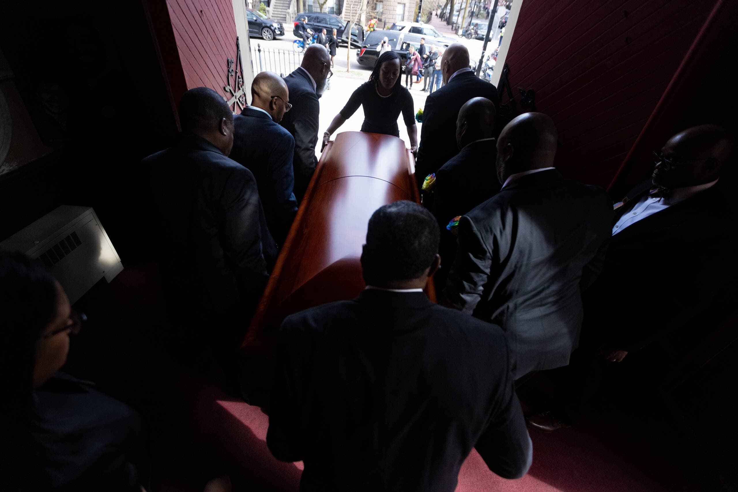 Pallbearers lift the casket of Mel King to carry it out of Union United Methodist Church to the hearse. (Jesse Costa/WBUR)