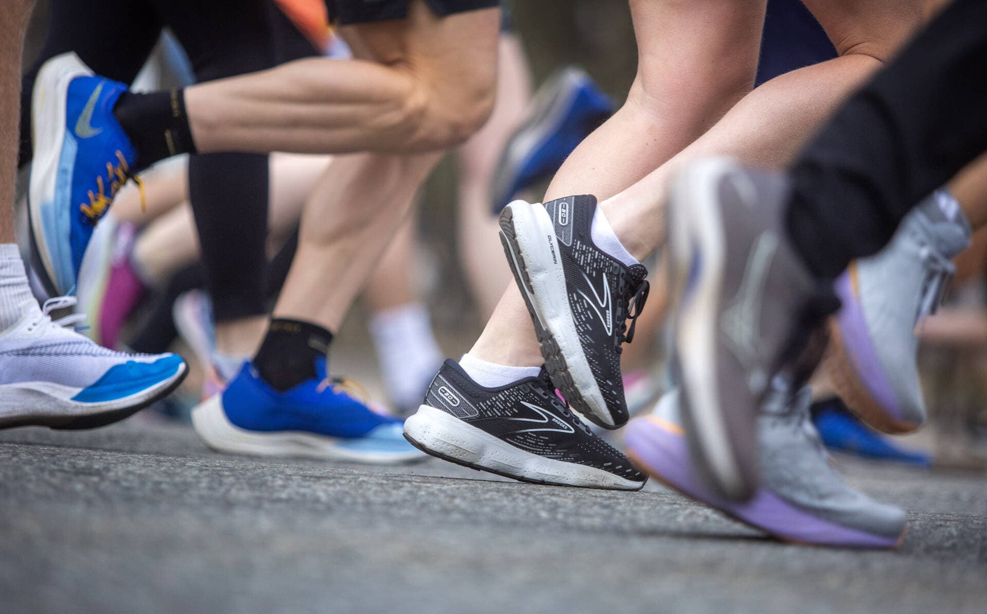 Runners in Boston's pre-marathon 5K run make their way along Arlington Street. (Robin Lubbock/WBUR)