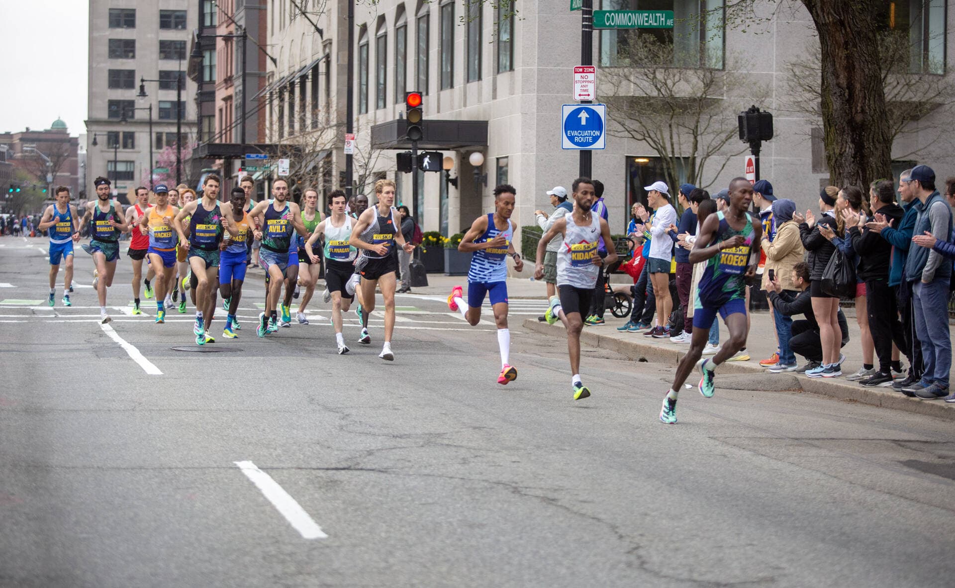 The elite men division of 5K runners speed down Arlington Street. (Robin Lubbock/WBUR)
