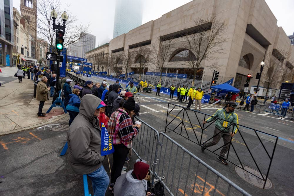 Spectators line the sides of Boylston Street waiting for the start of the Boston Marathon. (Jesse Costa/WBUR)