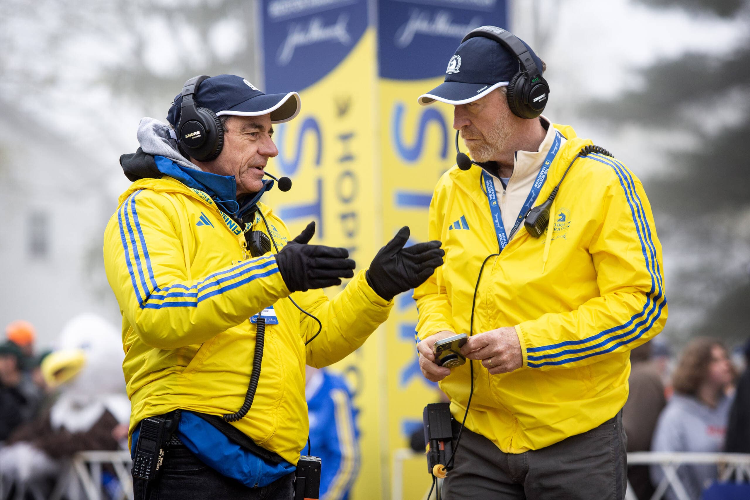 Boston Athletic Association officials talk at the starting line of the 127th Boston Marathon on Monday, April 17, 2023. (Robin Lubbock/WBUR)