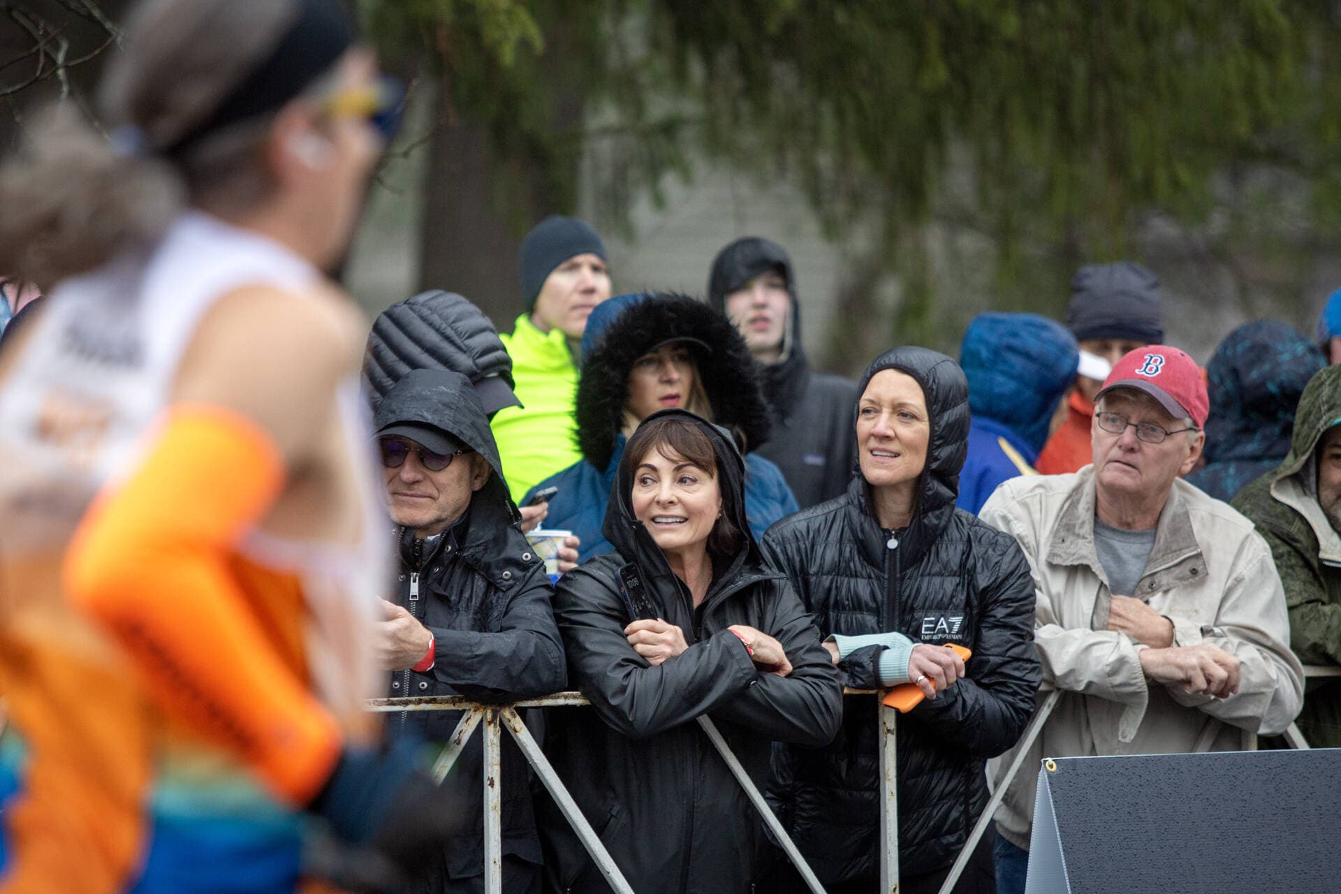 Spectators brave the rain to line the sidewalks in Hopkinton at the start of the 127th Boston Marathon. (Robin Lubbock/WBUR)