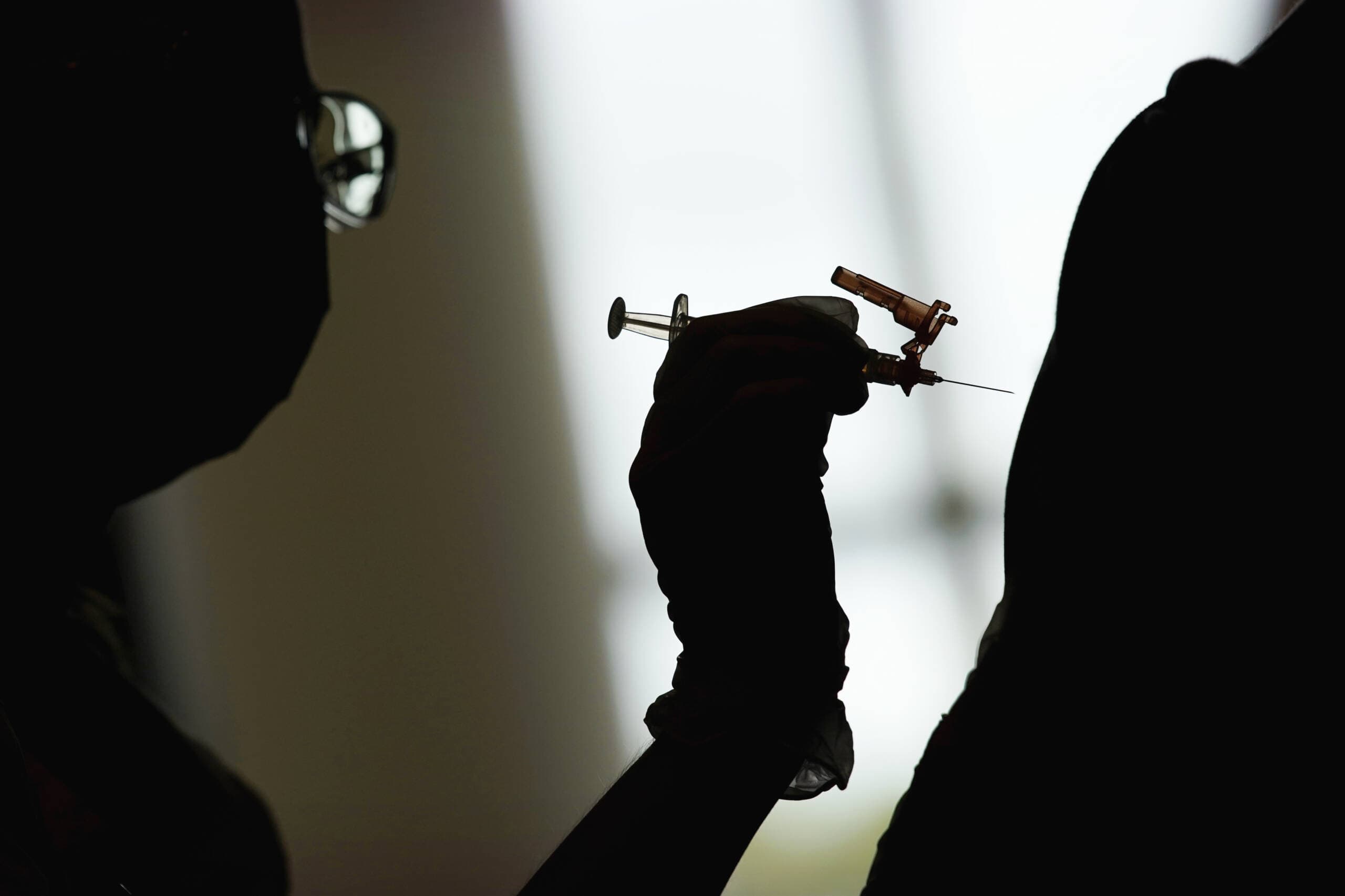 A nursing student administers the Moderna COVID-19 vaccine. (John Locher/AP)