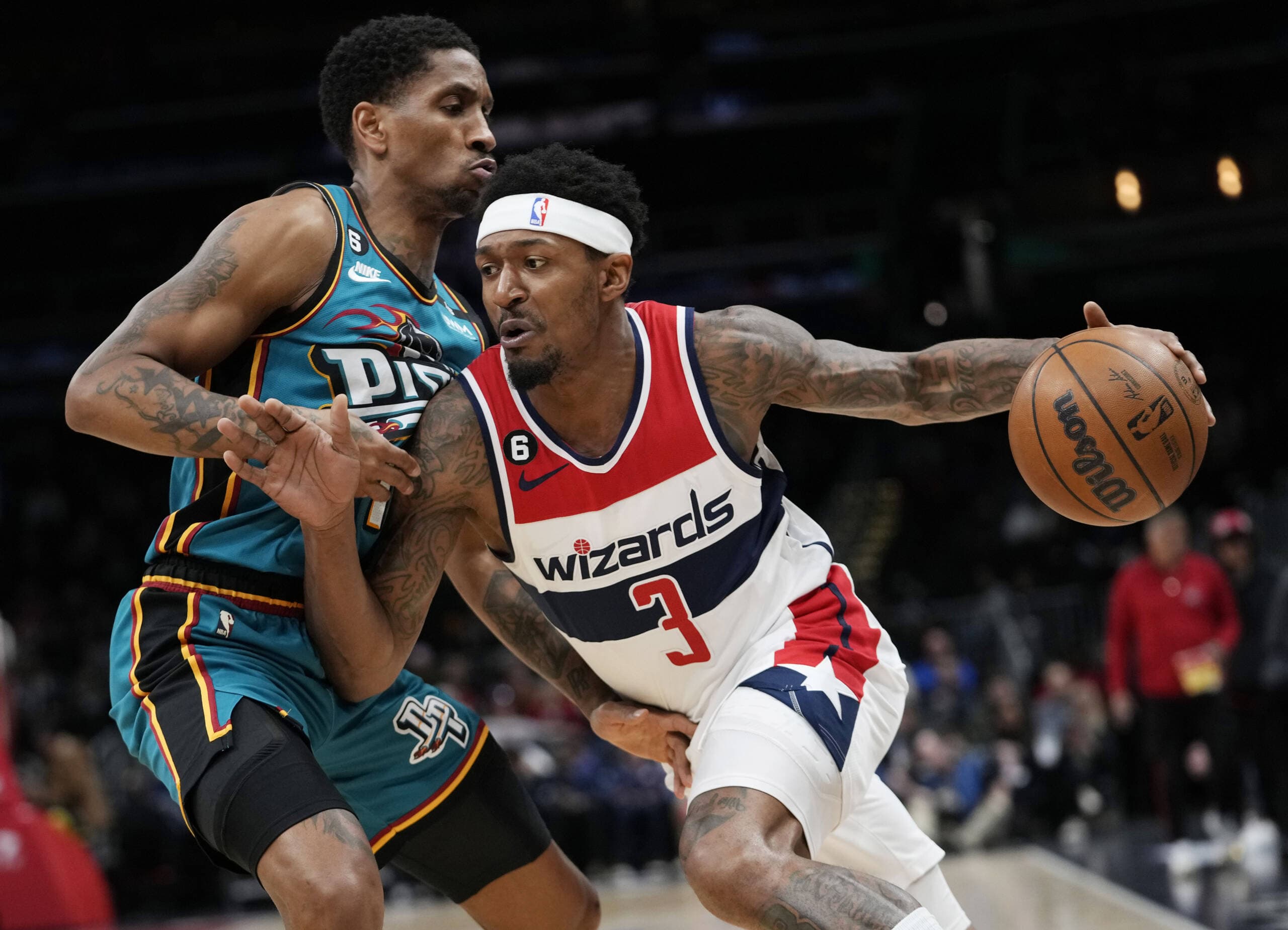 Washington Wizards guard Bradley Beal (3) drives around Detroit Pistons guard Rodney McGruder during the first half of an NBA basketball game, March 14, 2023, in Washington. A police report says Beal was walking down a tunnel to the Wizards’ locker room when a fan swore and accused Beal of causing the fan to lose a $1,300 bet. (Carolyn Kaster/AP)