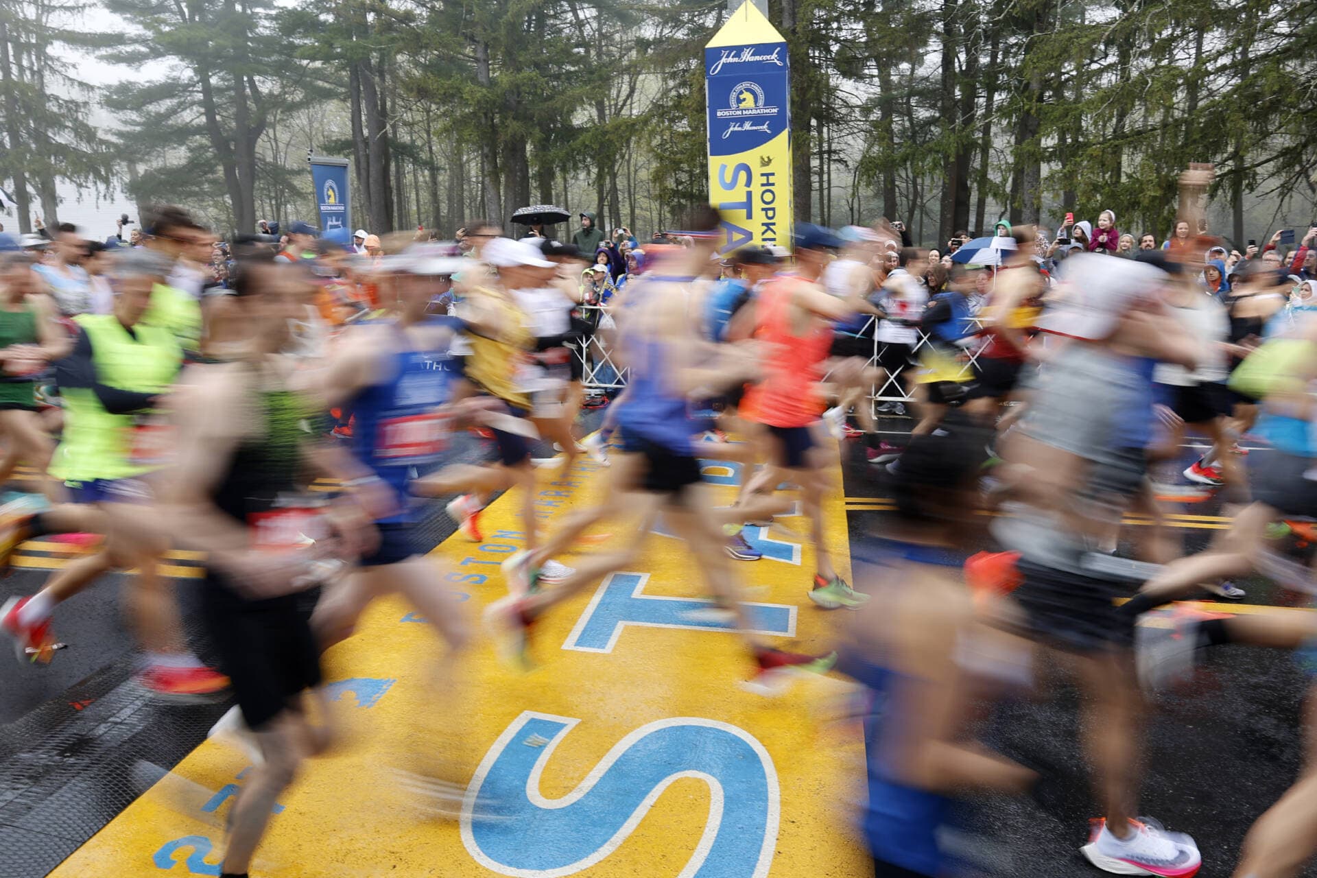 Runners cross the starting line during the 127th Boston Marathon in Hopkinton, Mass. (Mary Schwalm/AP)