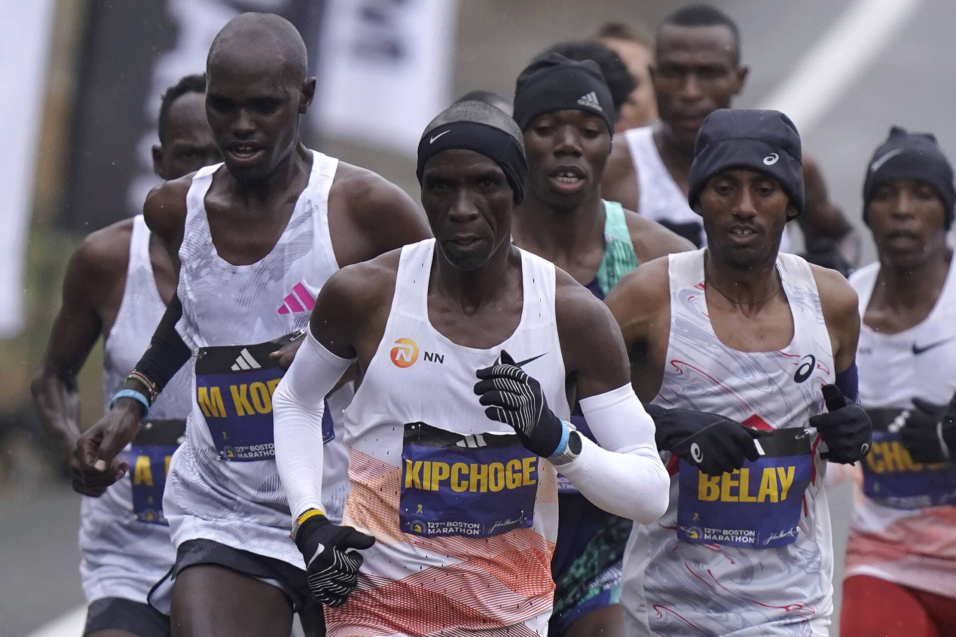 Eliud Kipchoge, of Kenya, center, runs ahead of Andualem Belay, of Ethiopia, second from right, at the front of a group of elite men, along the course of the 127th Boston Marathon, Monday, April 17, 2023, in Framingham, Mass. (Steven Senne/AP)