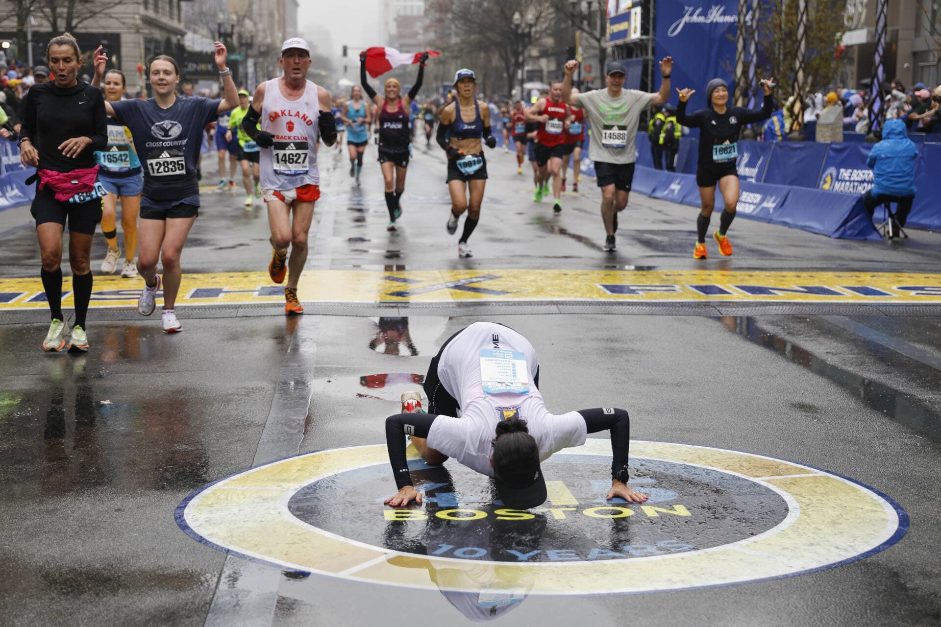 Maria Correia of Brazil kisses the ground after crossing the finish line of the127th Boston Marathon Monday, April 17, 2023, in Boston. (Winslow Townson/AP)