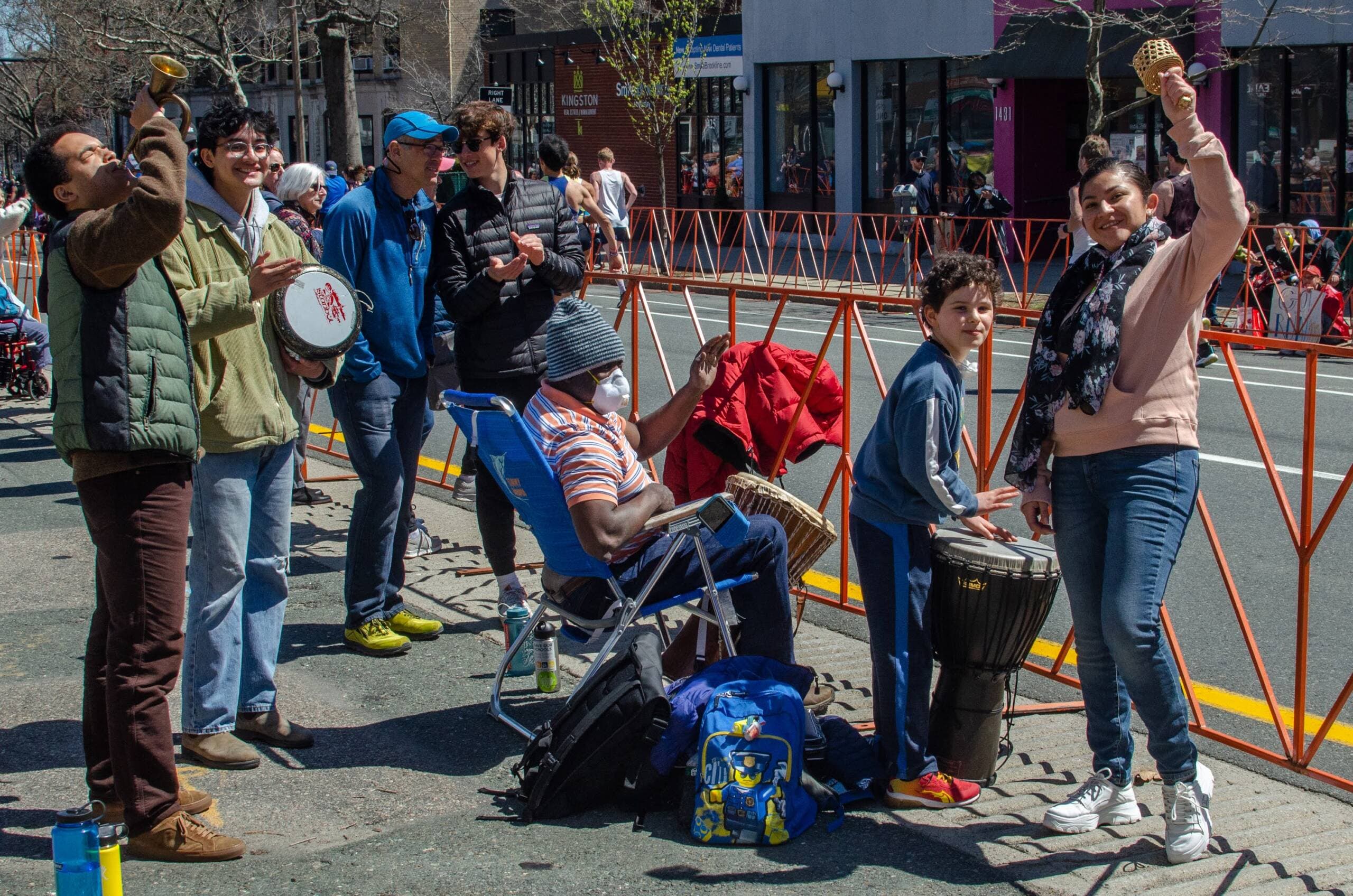 The Nsangou and Koch and Moore families have played music together on Beacon Street during the marathon for years. They are photographed here in 2022. (Sharon Brody/WBUR)