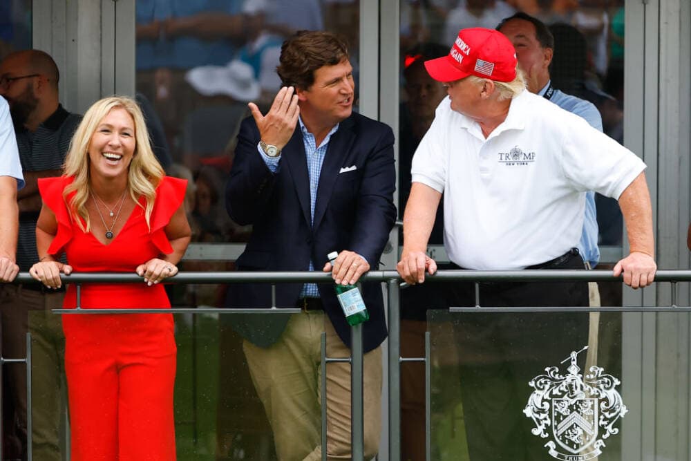 Former President Donald Trump, Tucker Carlson and Rep. Marjorie Taylor Greene during the 3rd round of the LIV Golf Invitational Series Bedminster on July 31, 2022 at Trump National Golf Club in Bedminster, New Jersey. (Rich Graessle/Icon Sportswire via Getty Images)