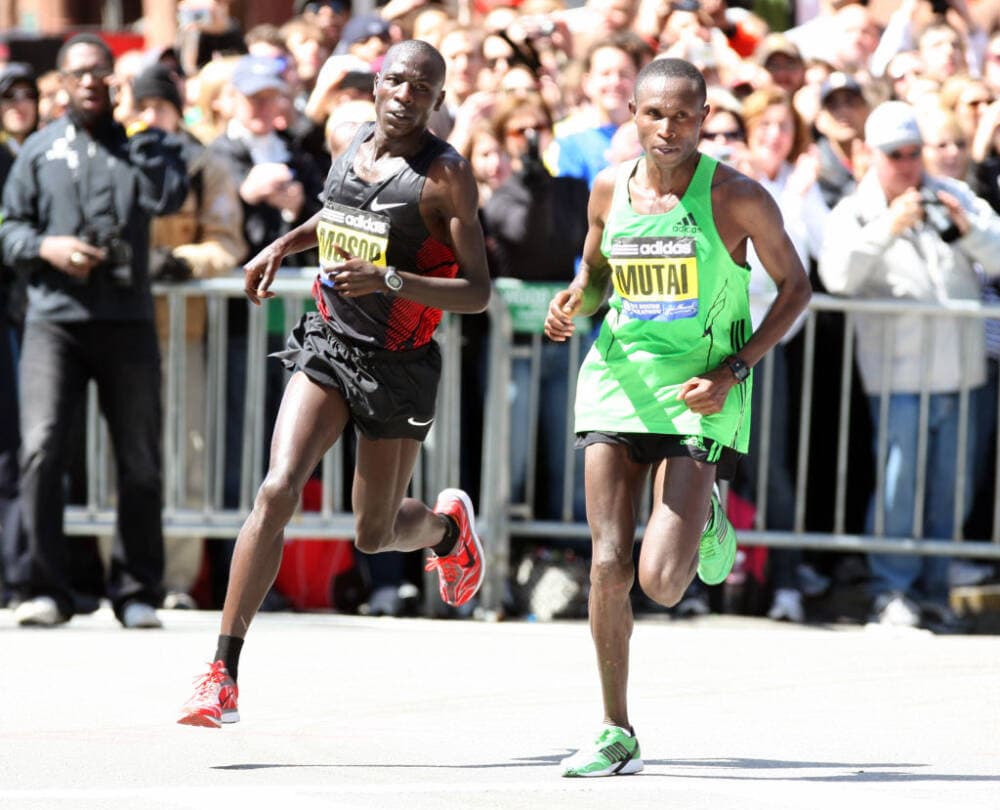 Geoffrey Mutai rounds the corner onto Boylston St. with Moses Mosop at his side as they approach the finish line during the Boston Marathon men's race on April 18, 2011. (John Wilcox/MediaNews Group/Boston Herald via Getty Images)