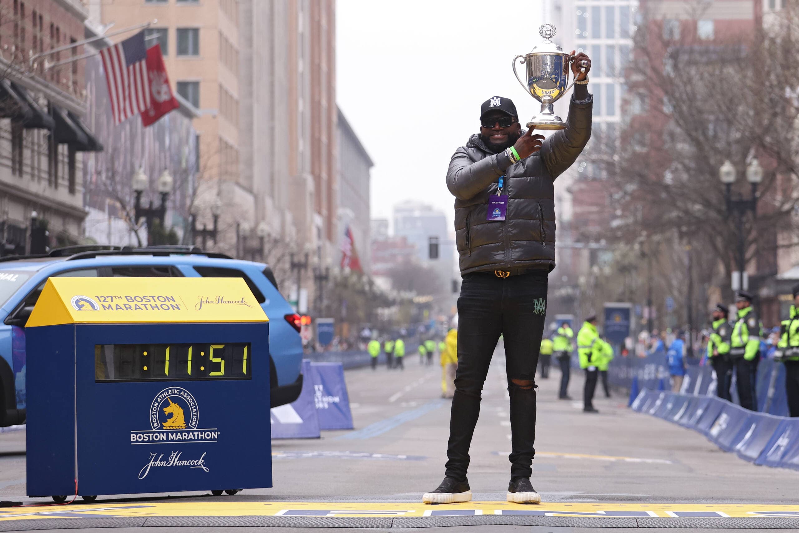 Former Boston Red Sox baseball player David Ortiz poses with the trophy at the Boston Marathon finish line. He's the grand marshal of the race this year. (Maddie Meyer/Getty Images)