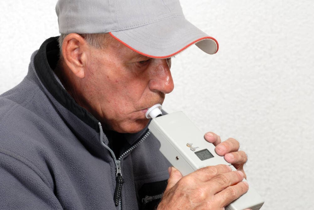 Person taking a breathalyzer test. (Getty)
