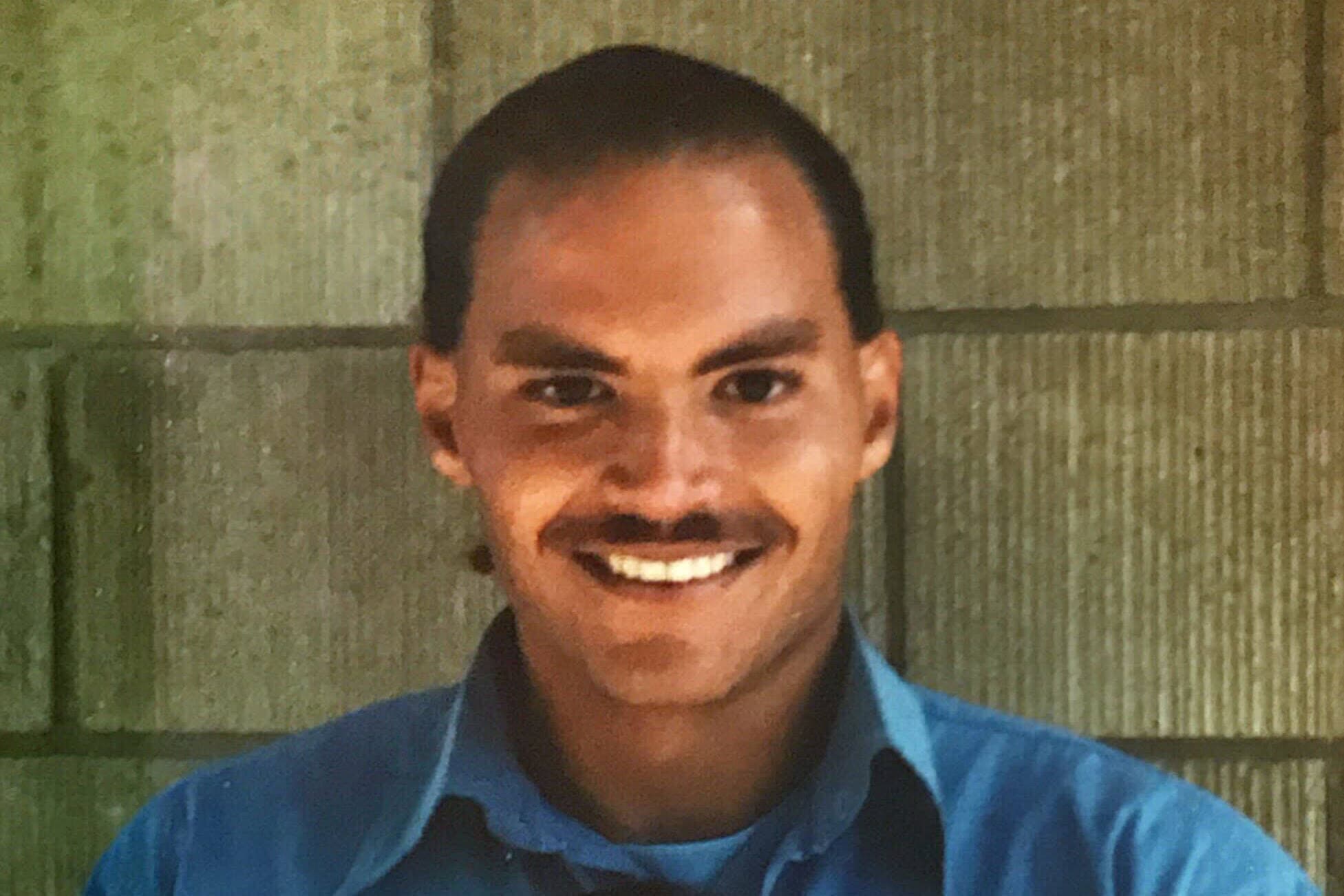 A photo of Jacob Wideman, a multiracial man with short hair and a mustache. 