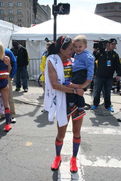 Kara Goucher with her son, Colt, at the finish line of the Boston Marathon on April 15, 2013. Goucher placed sixth that year. (Courtesy Kara Goucher)