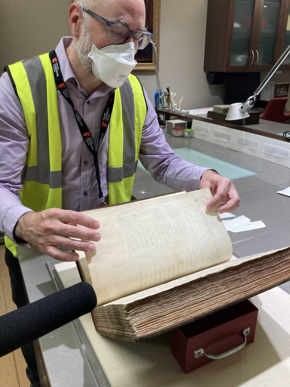 Greg Prickman, the Folger Library's Director of Collections, pages through Henry Folger's favorite First Folio. (Scott Tong/Here & Now)