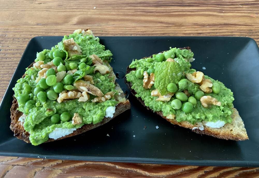 Pea and mint puree crostini with goat cheese and walnuts. (Kathy Gunst/Here & Now)