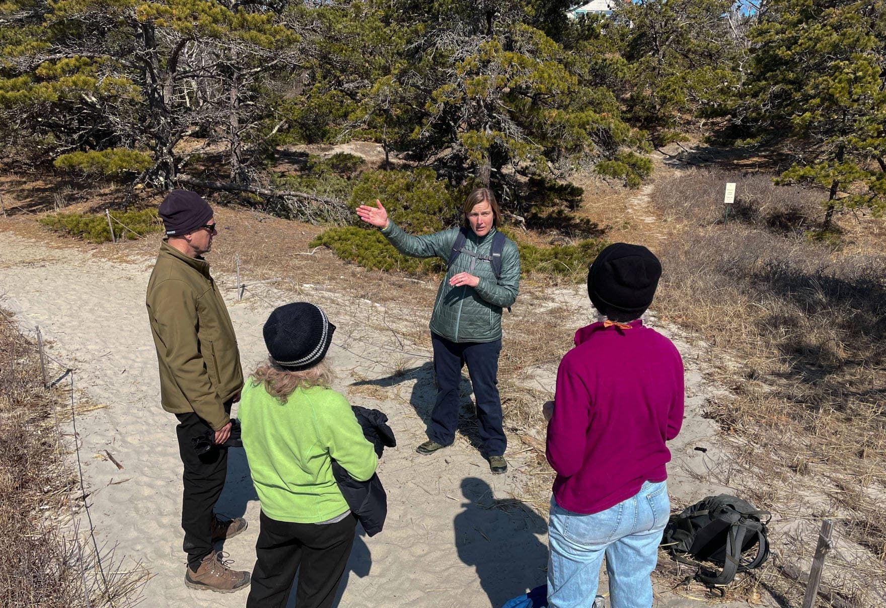 Caitlin Cleaver, director of the Bates-Morse Mountain Conservation Area, describes some of the dune processes to visitors. (Murray Carpenter/Maine Public)