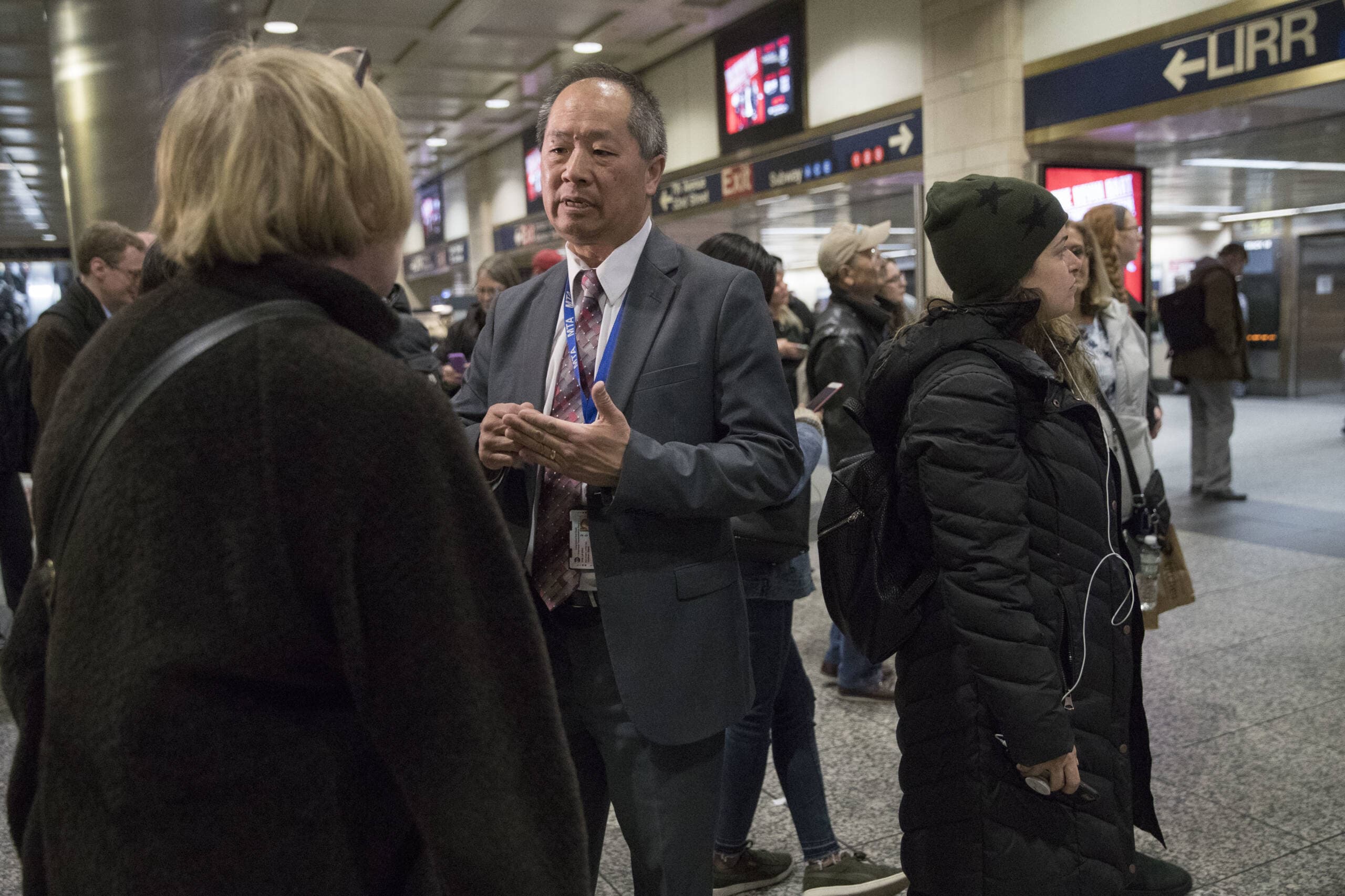 MBTA General Manager Phil Eng, center, talks to evening rush hour commuters at Penn Station, April 17, 2018, in New York when he was the president of Long Island Rail Road. (Mary Altaffer/AP)