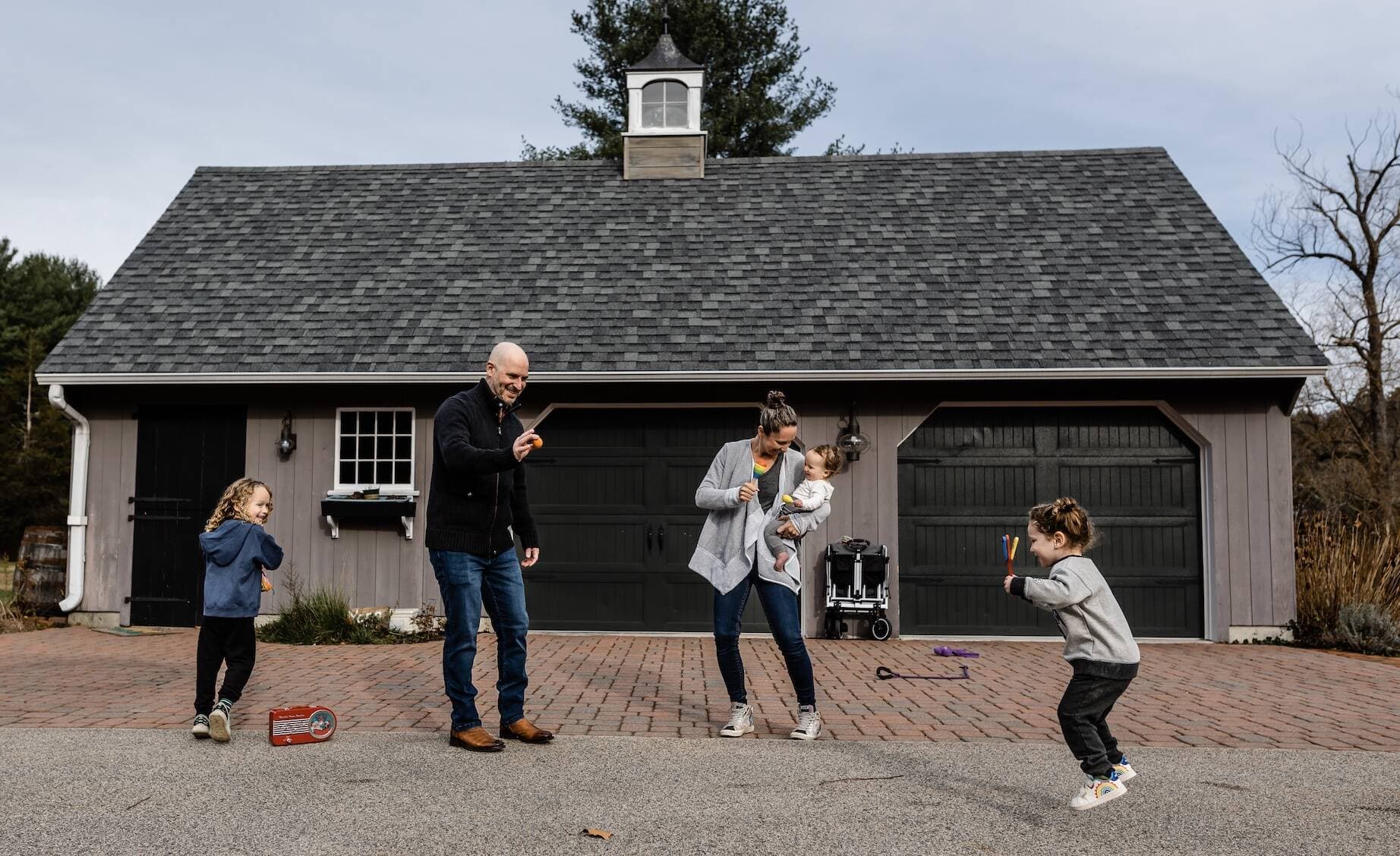 Boston Marathon bombings survivor Meghan Zipin plays with her husband and children in their driveway. (Courtesy Katie Goodall)