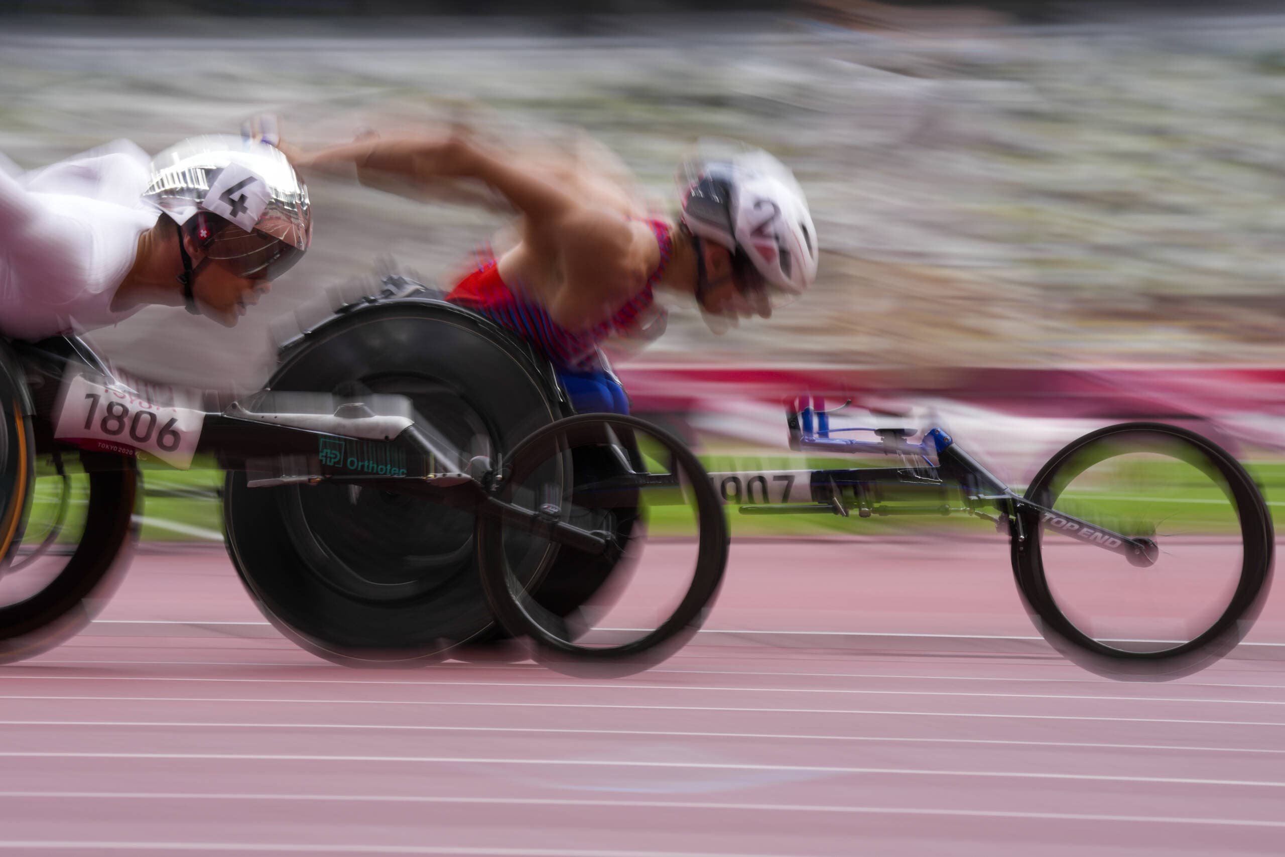 Switzerland's Marcel Hug, left, and United States' Daniel Romanchuk compete in the men's T54 1500-meters final during the 2020 Paralympics in Tokyo on Aug. 31, 2021. (Eugene Hoshiko/AP)