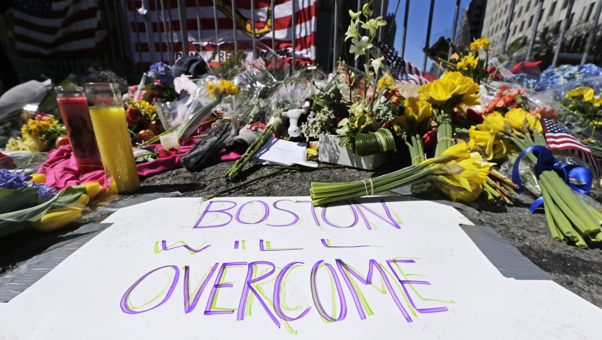 In this April 17, 2013 photograph, a makeshift memorial of flowers and signs adorn a barrier, two days after the explosions at Boylston Street near the finish line of the Boston Marathon. (Charles Krupa/AP)