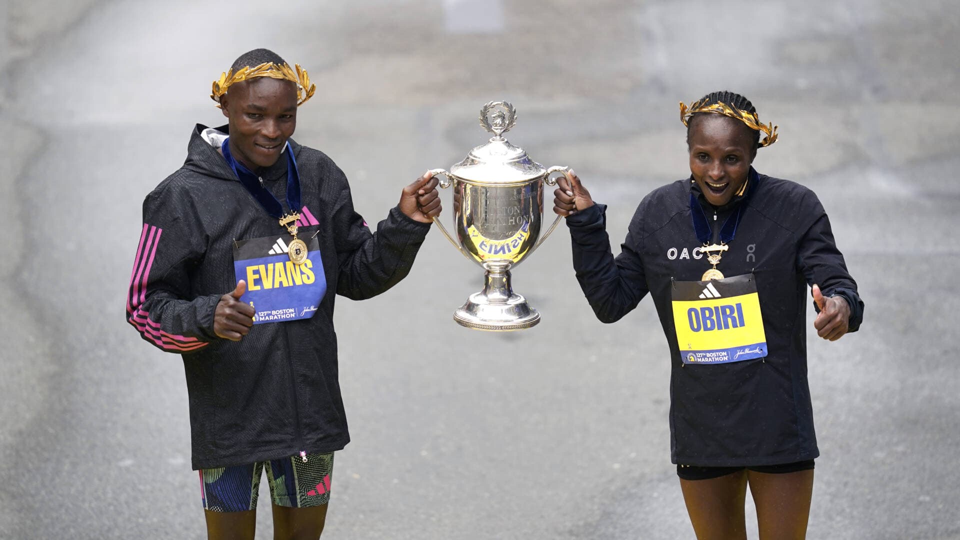Evans Chebet, left, and Hellen Obiri, both of Kenya, pose on the finish line after winning the men's and women's division of the Boston Marathon on April 17 in Boston. (Charles Krupa/AP)