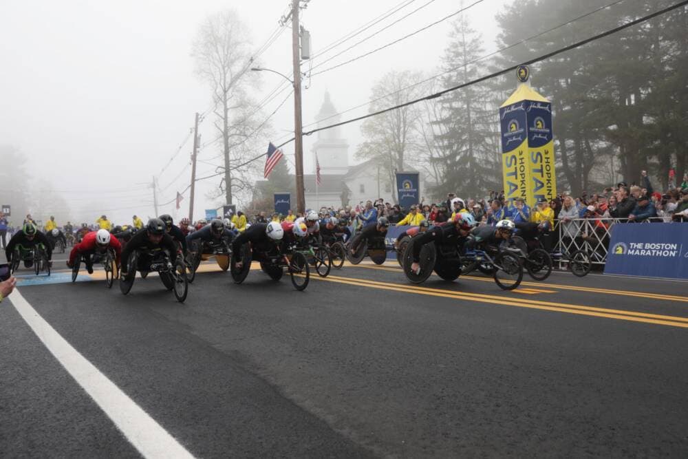 The first racers in this year's Boston Marathon take off from the starting line in Hopkinton. (Robin Lubbock/WBUR)
