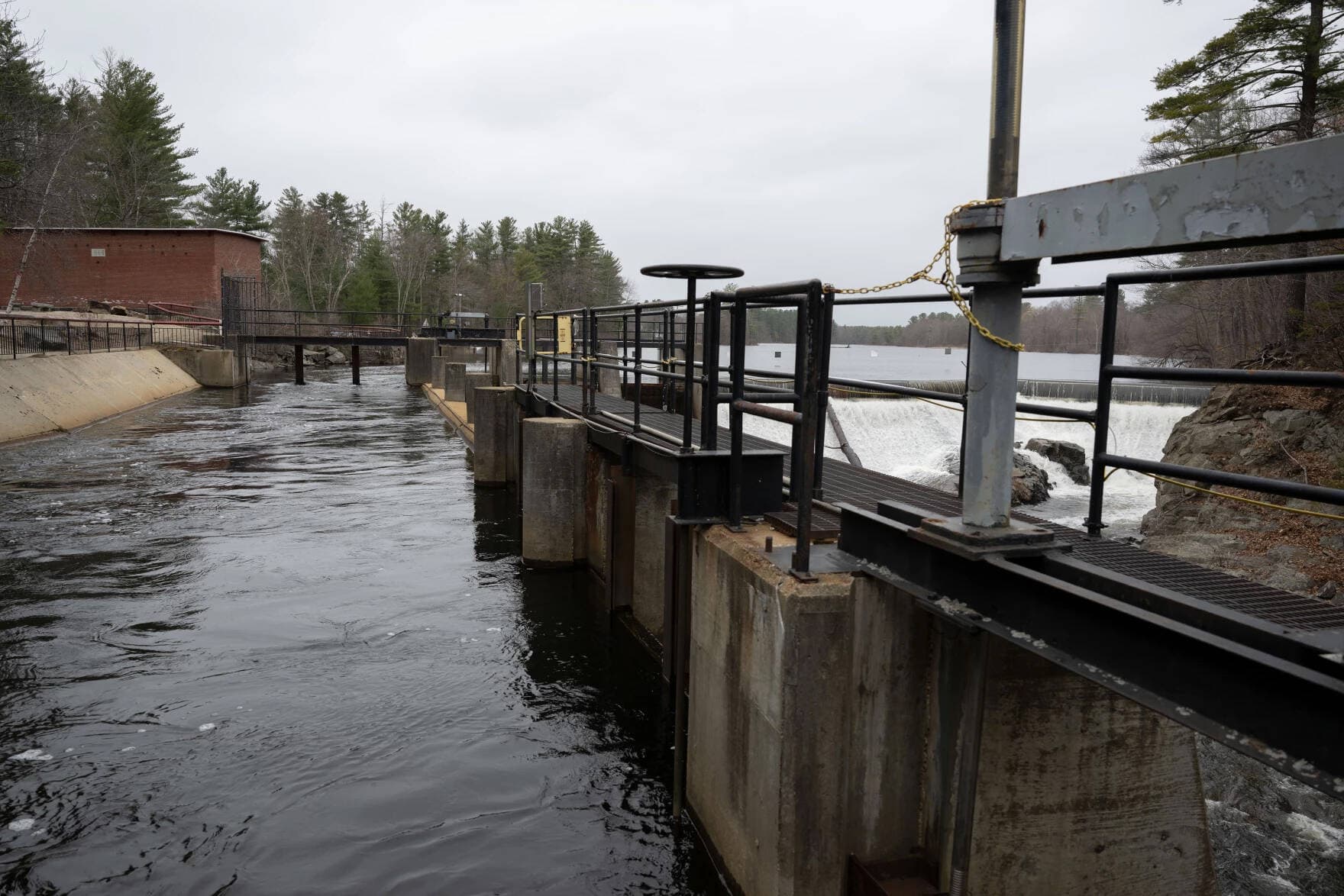 Water runs through the Mine Falls Hydroelectric Facility on April 5, in Nashua, N.H. Officials say these dams could be part of community power programs in the future. (Raquel C. Zaldívar/New England News Collaborative)