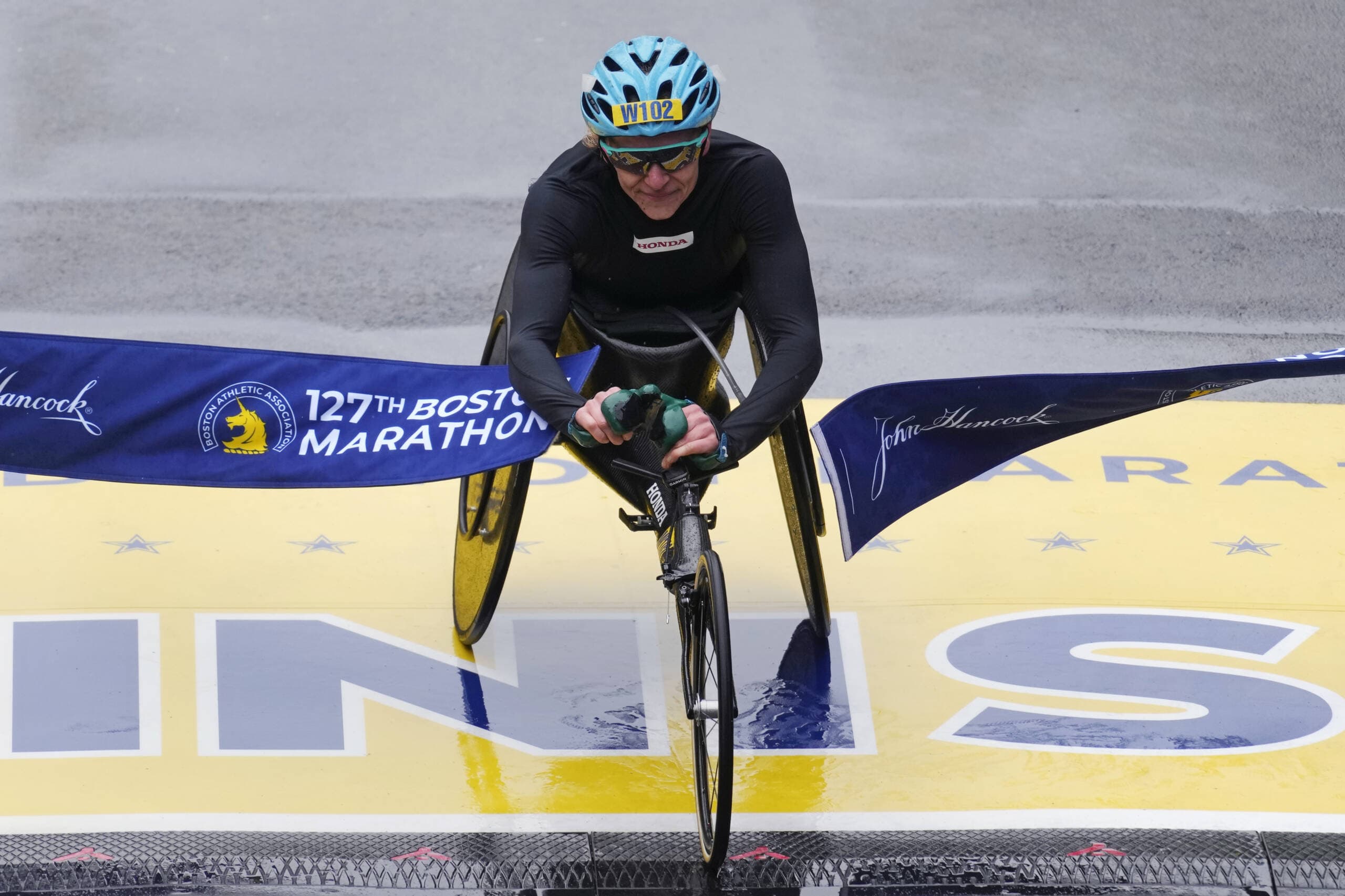Susannah Scaroni, of Urbana, Ill., breaks the tape to win the women's wheelchair division of the Boston Marathon. (Charles Krupa/AP)