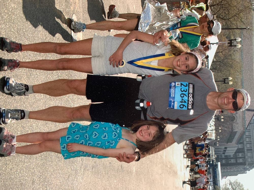 Tim Timmermann at the finish line of the Boston Marathon with his daughters, Addison, left, and Hadley, who were ages 11 and 7, in 2012. (Courtesy Tracey Palmer)