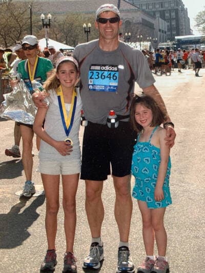 Tim Timmermann at the finish line of the Boston Marathon with his daughters, Addison, left, and Hadley, who were ages 11 and 7, in 2012. (Courtesy Tracey Palmer)