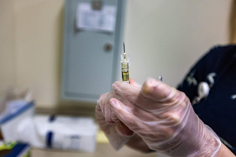 Dr. Stephanie Stratigos fills a syringe with a dose of Sublocade to administer to Joey Kinghorn. (Jesse Costa/WBUR)