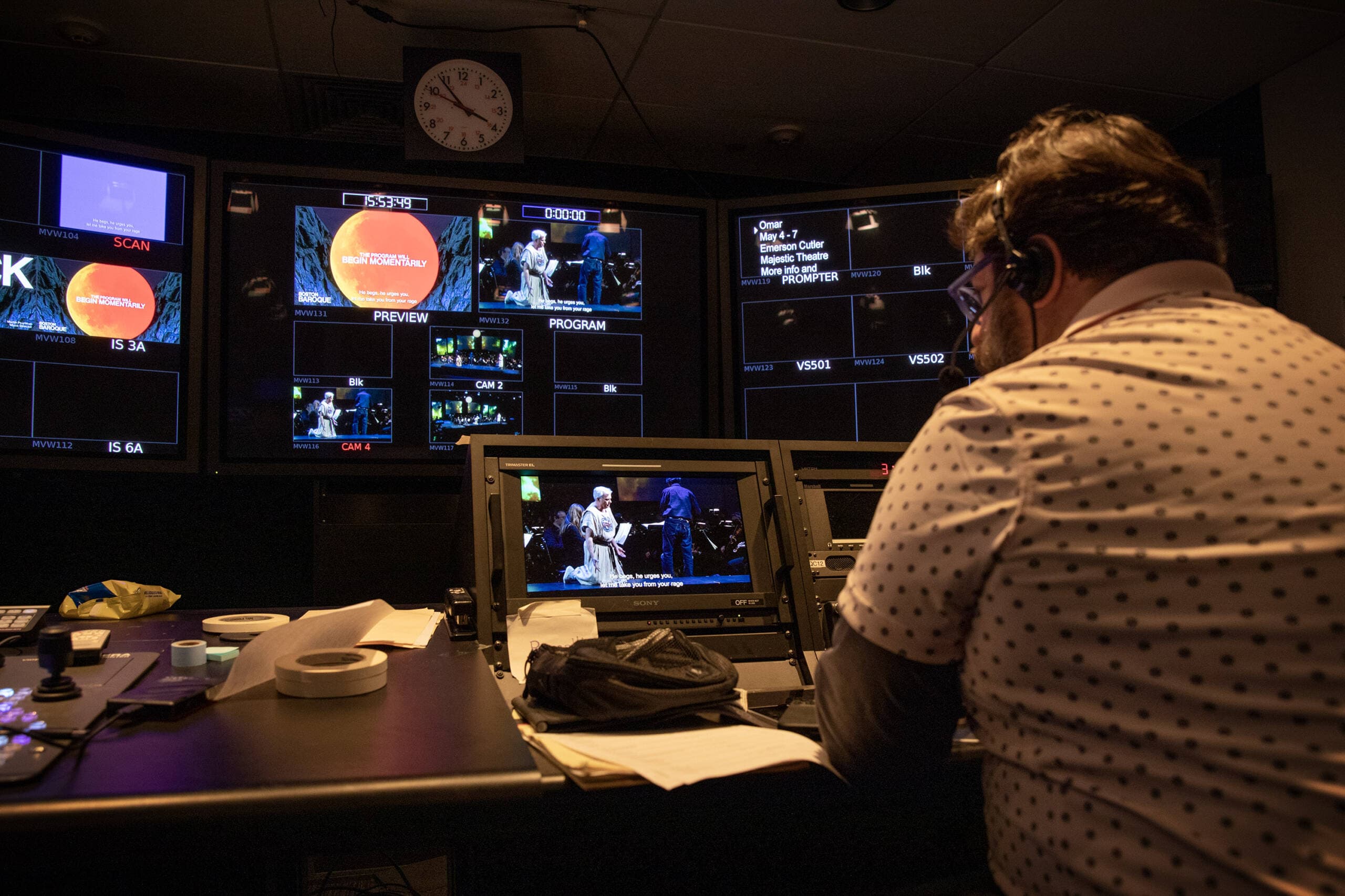 In the control room behind the stage, Matthew Principe directs the program feed of Boston Baroque's production of "Iphigénie en Tauride." (Robin Lubbock/WBUR)