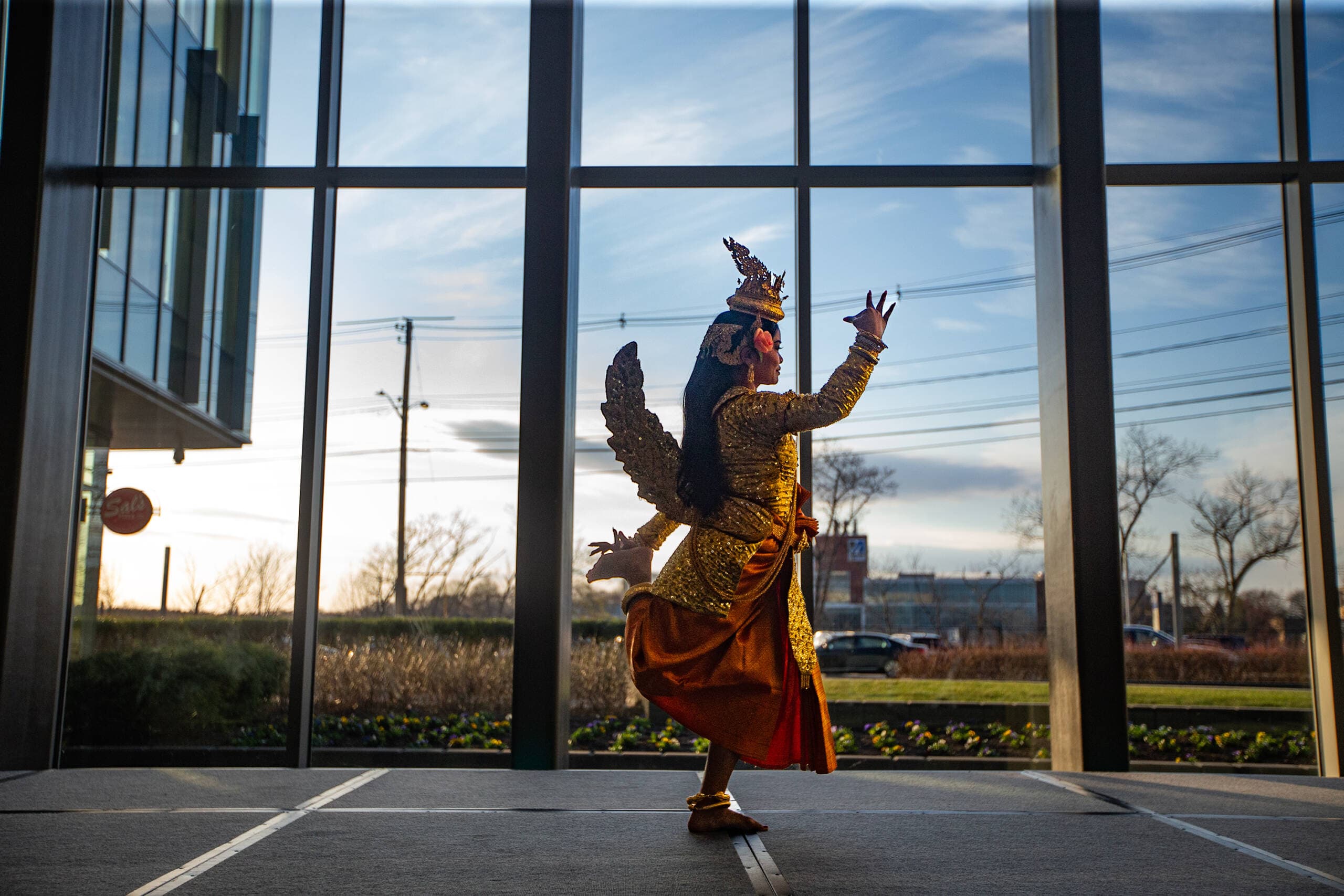 Channa Sath begins the traditional Cambodian dance, Sovann Maccha, during a performance by the Angkor Dance Troupe at UMass Lowell. (Jesse Costa/WBUR)